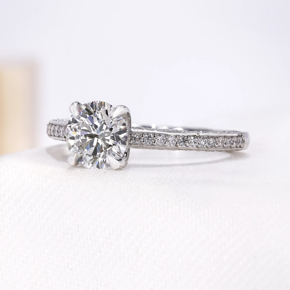 Antiquecut white gold ring with round center diamond and pavé band