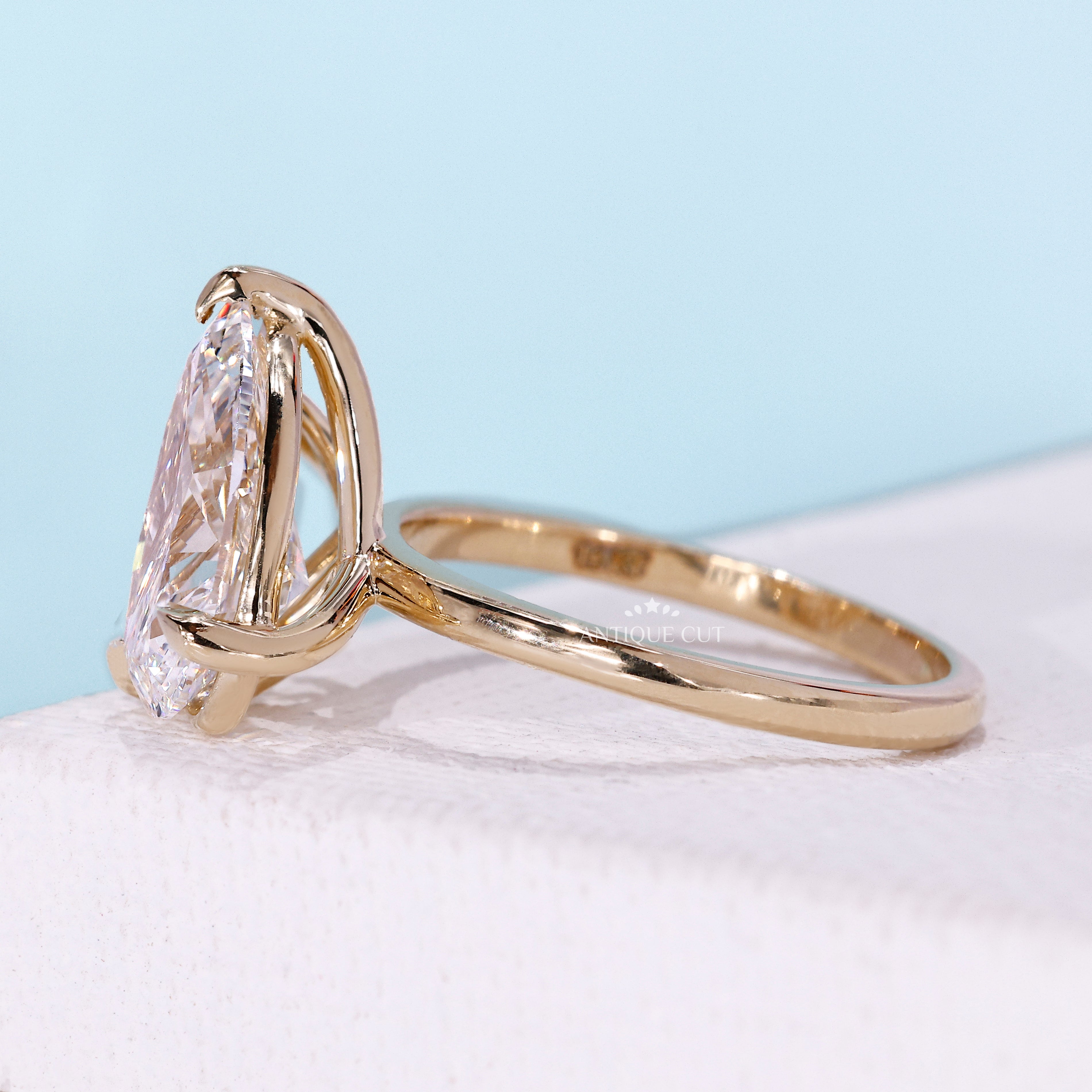 Yellow gold diamond ring featuring pear cut diamond toi et moi design