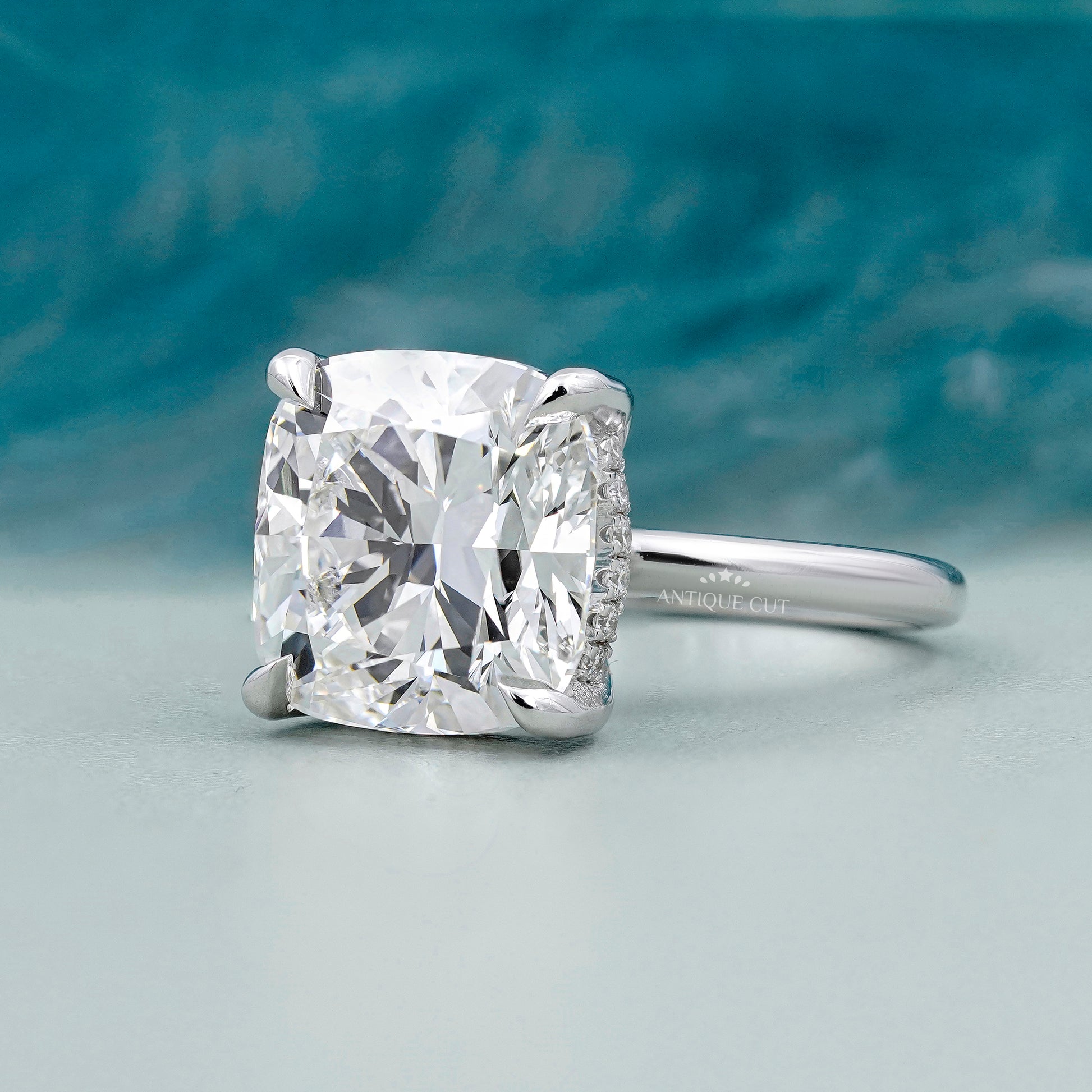 White gold cushion cut engagement ring with subtle hidden halo