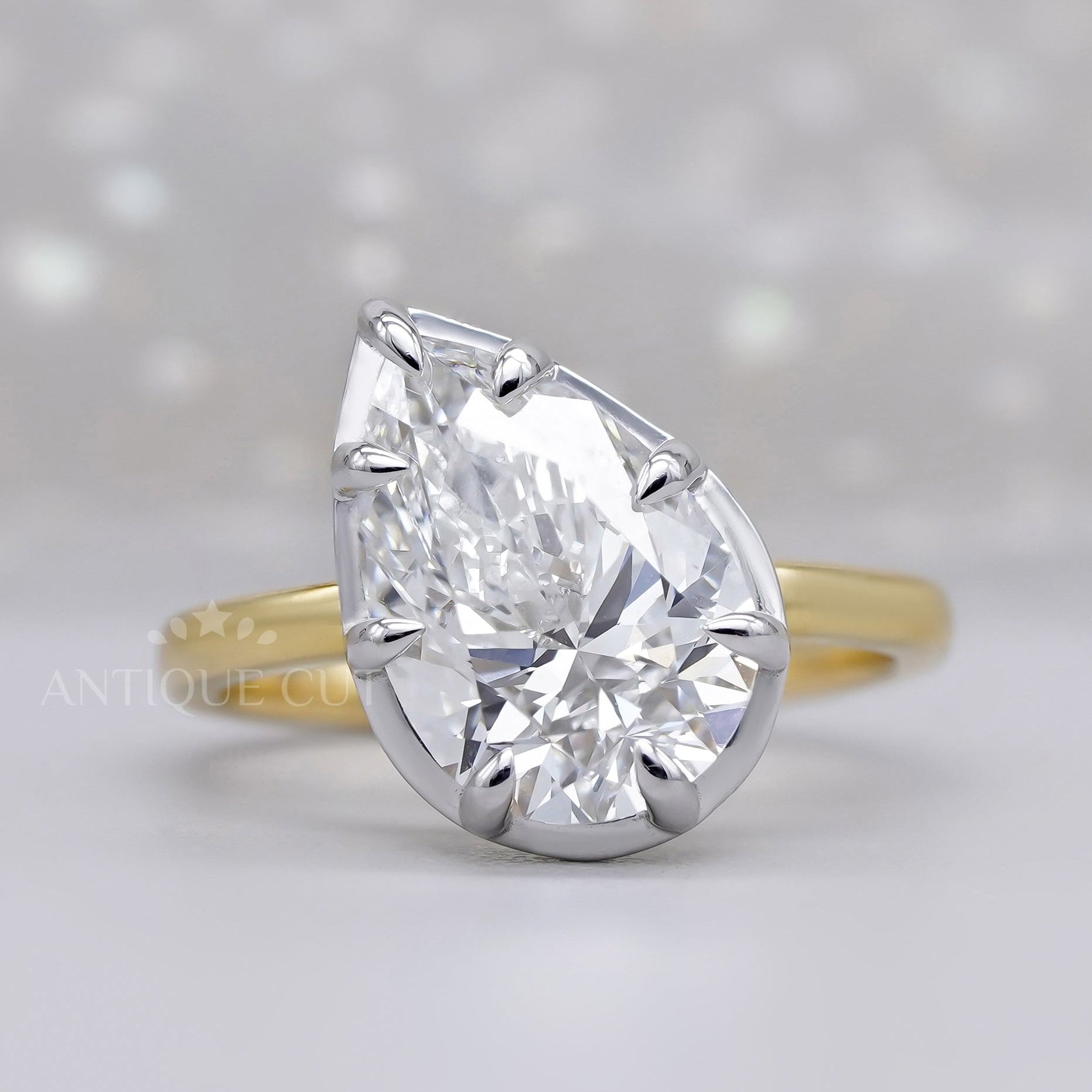 Pear two tone engagement ring with solitaire diamond