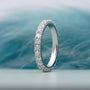 Silver ring with diamonds on a soft blue background

