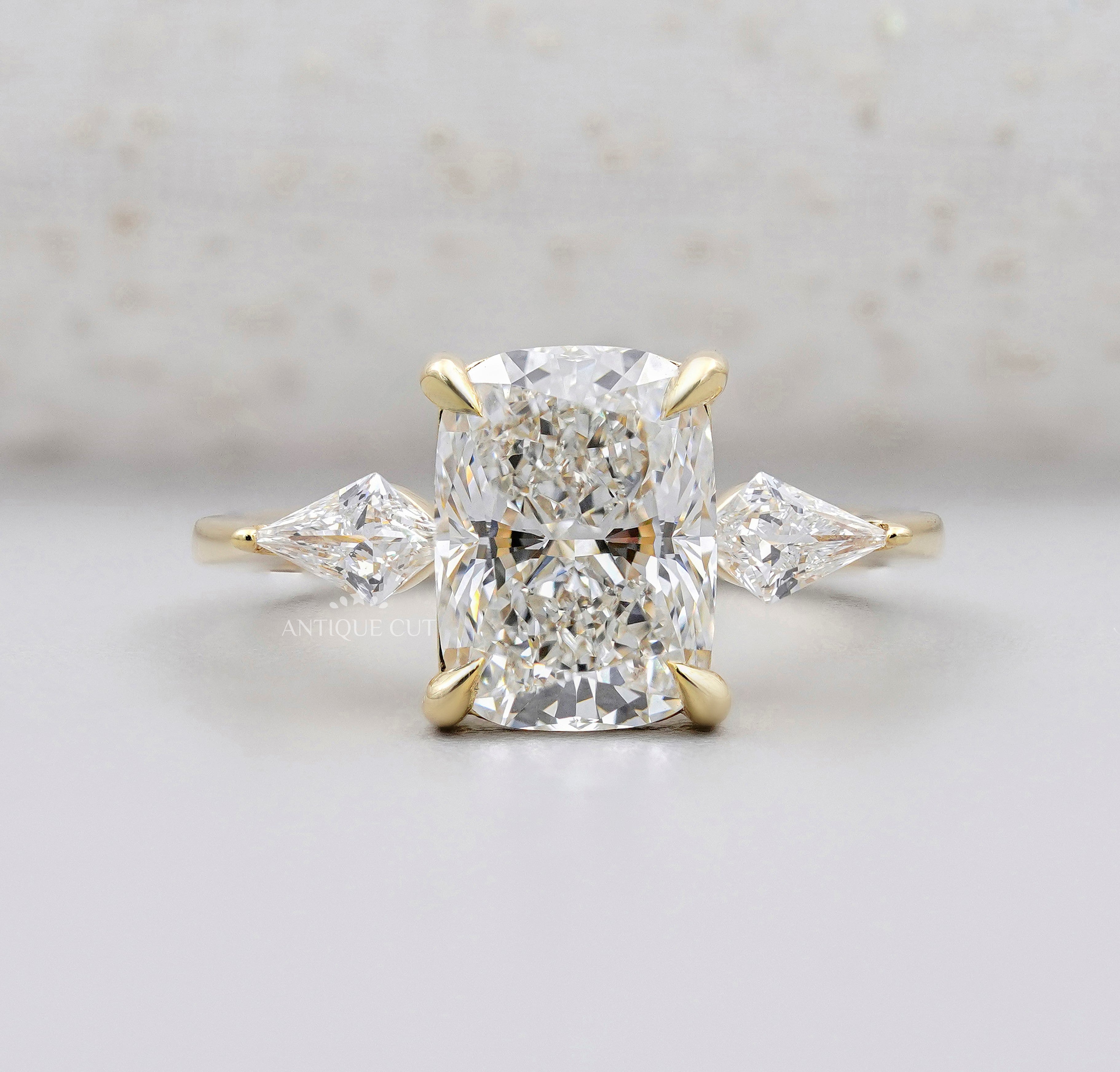 Elongated cushion cut diamond engagement ring with kite side stones in yellow gold
