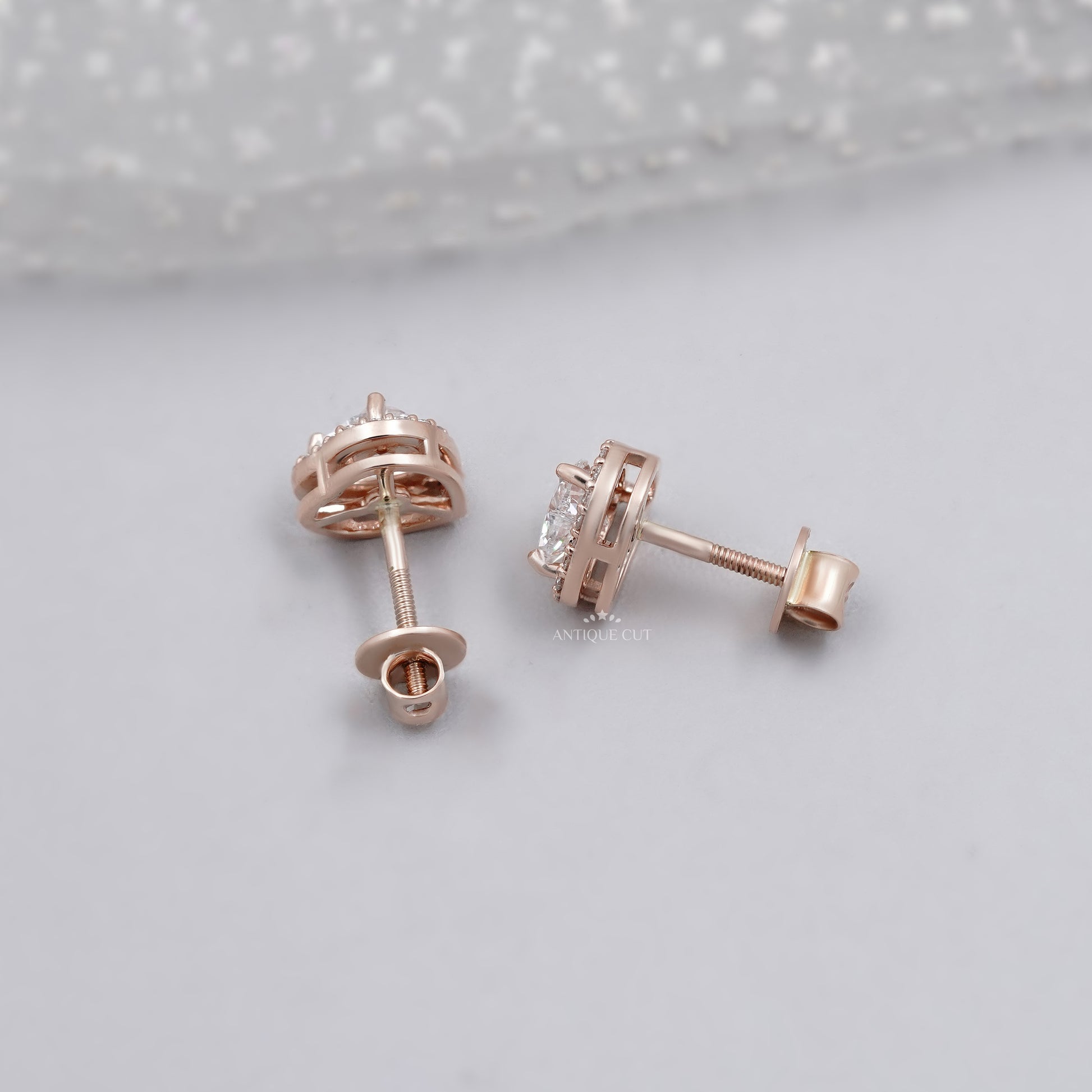 Rose gold heart diamond earrings with surrounding halo diamonds