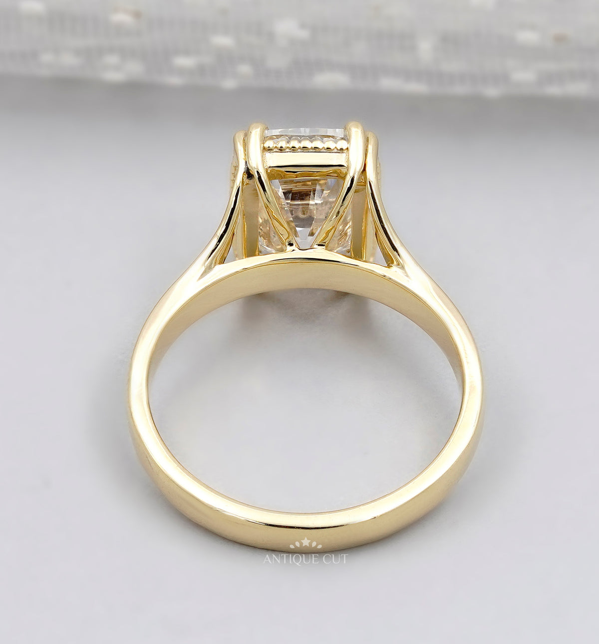 Elongated rectangular diamond engagement ring in polished yellow gold