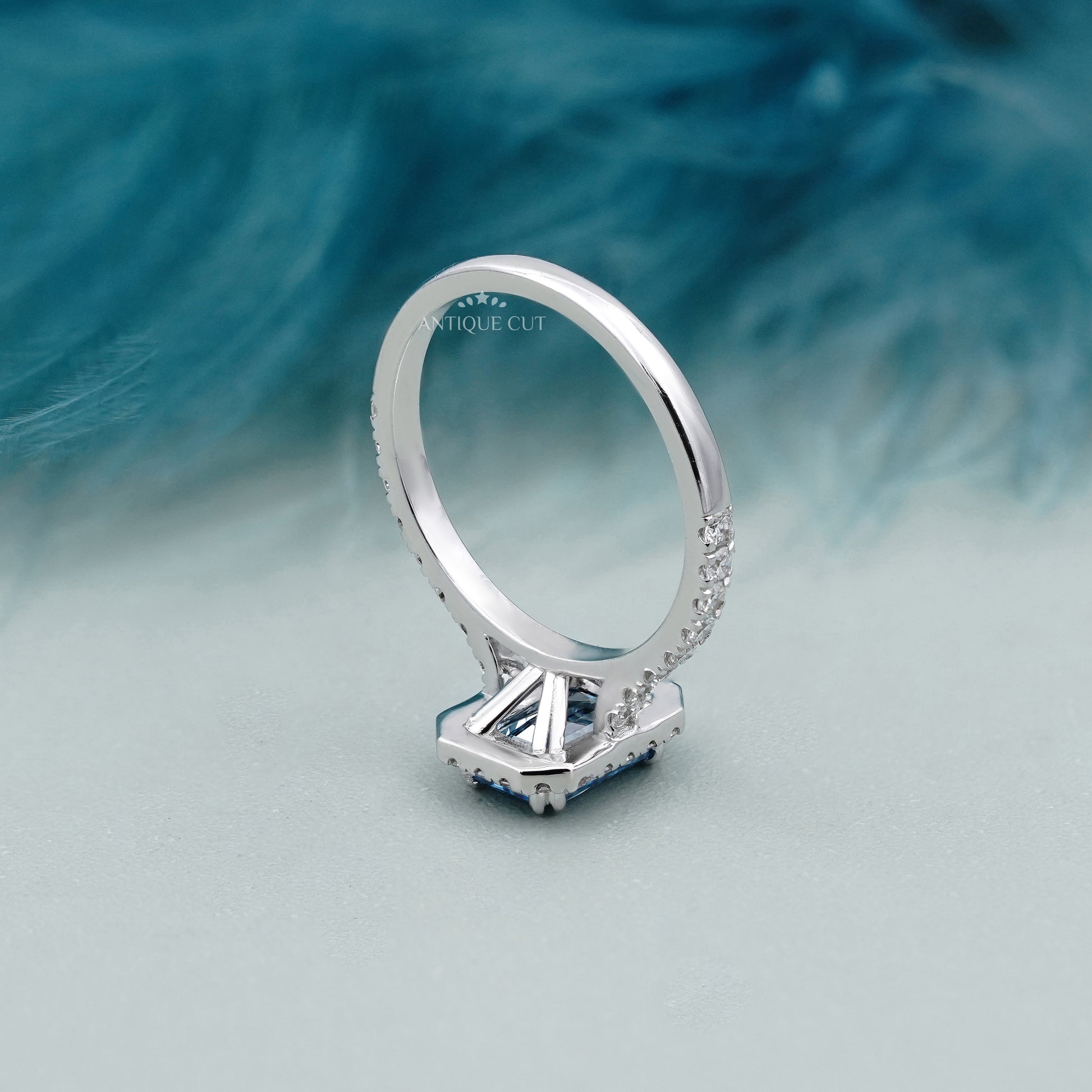 Emerald halo fancy blue diamond ring with pave band

