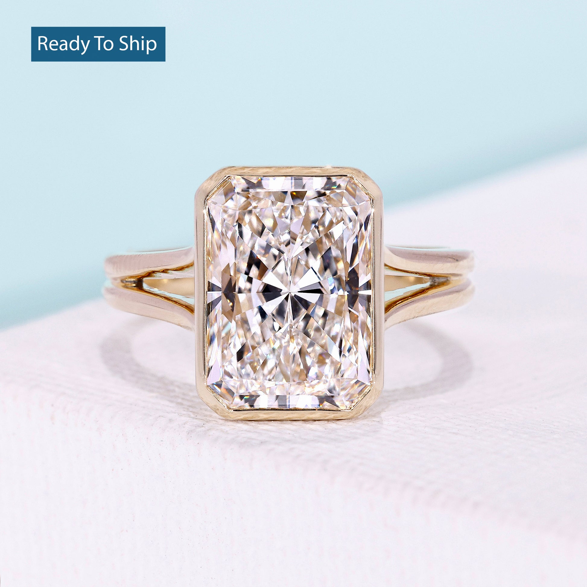 Radiant cut split shank engagement ring in yellow gold
