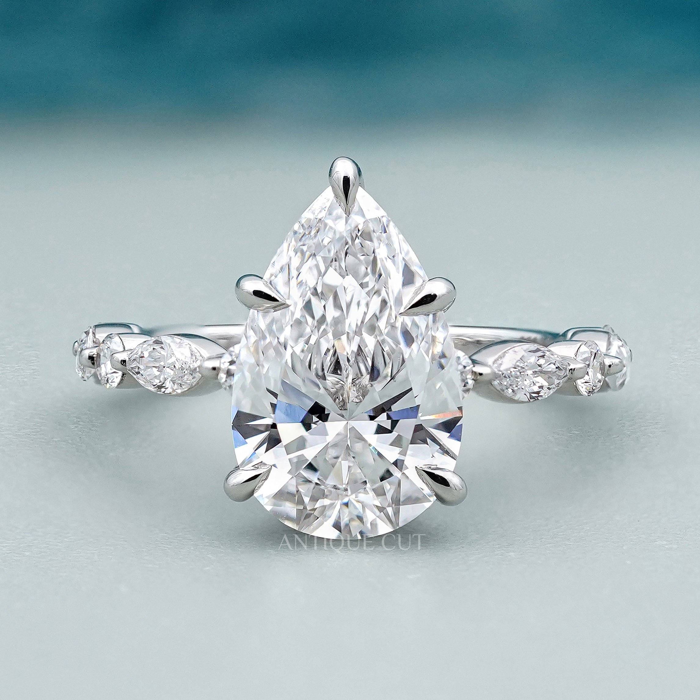 Pear side stone engagement ring in white gold