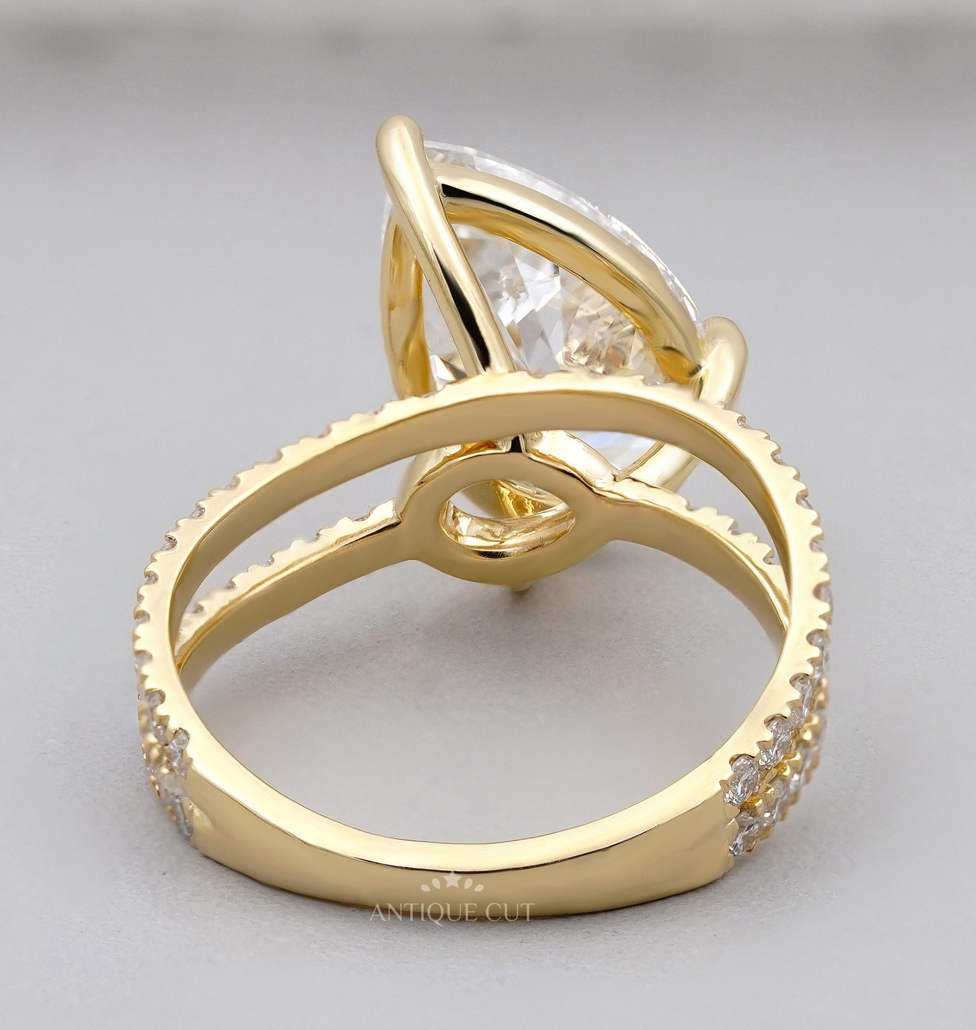 Pave diamond ring featuring pear cut center diamond design
