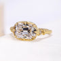 Yellow gold engagement ring with cushion center and small round side stones