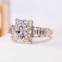 Side view of yellow gold engagement ring with emerald cut side stones