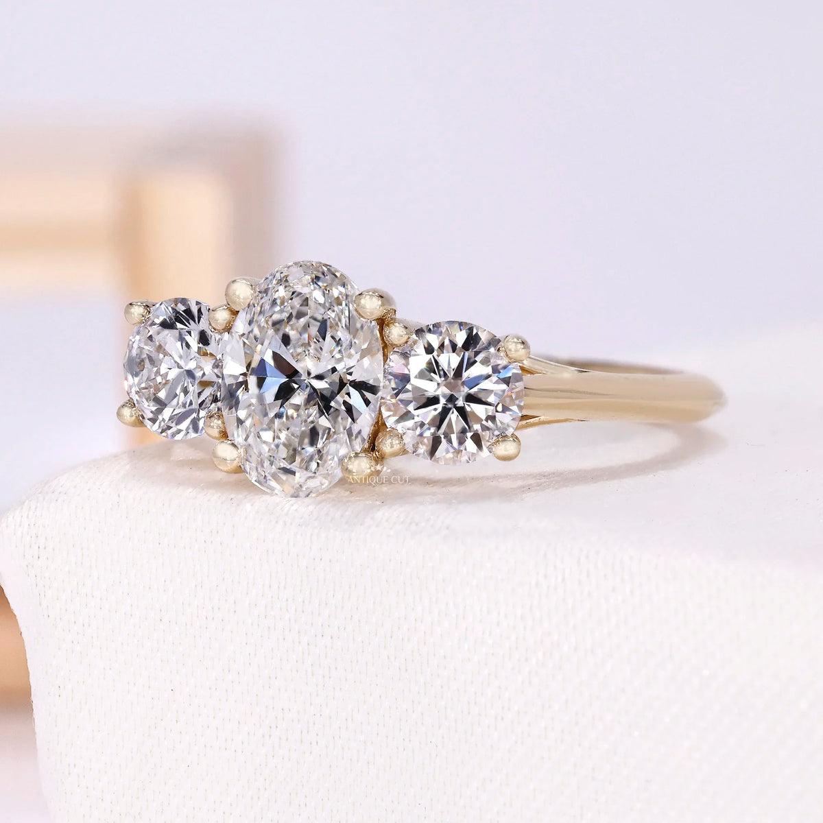 1.50 Carat Lab Grown Oval Cut Center Diamond & Two Round Side Stones With Trellis Gallery Setting