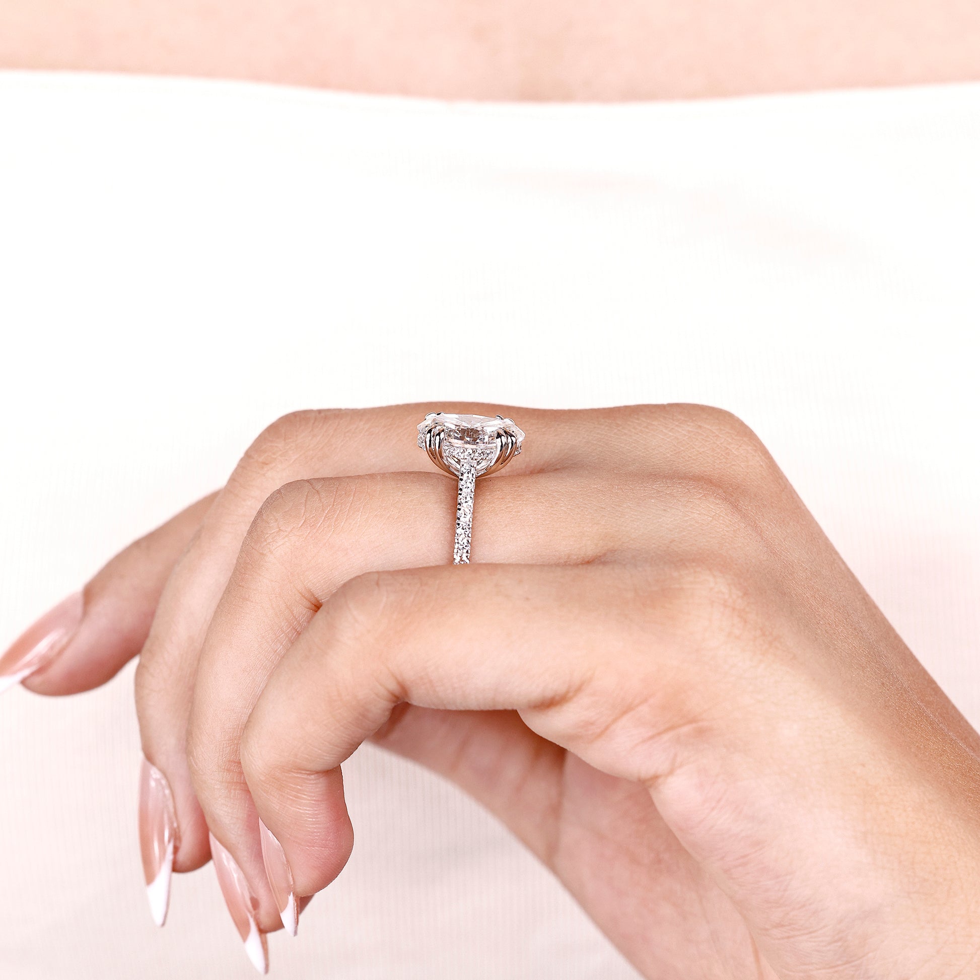 White gold oval engagement ring with secure double claw prongs
