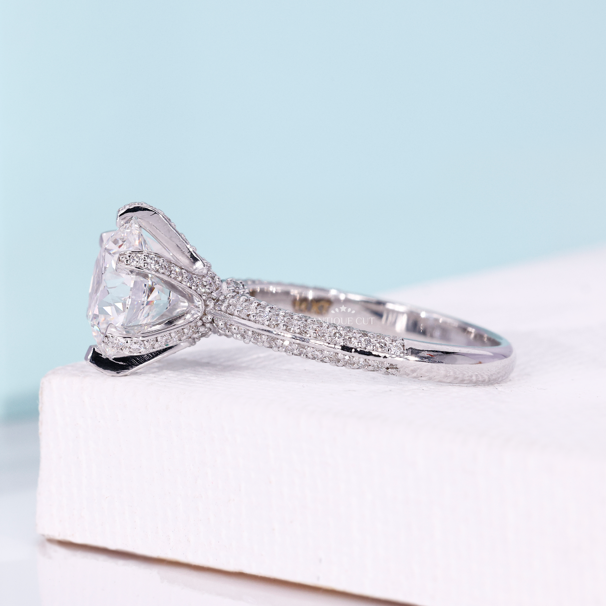 Round cut pavé band ring with three row diamond design