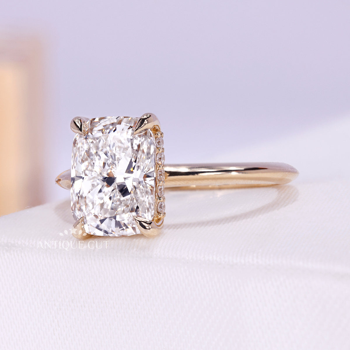 Hidden halo elongated cushion engagement ring