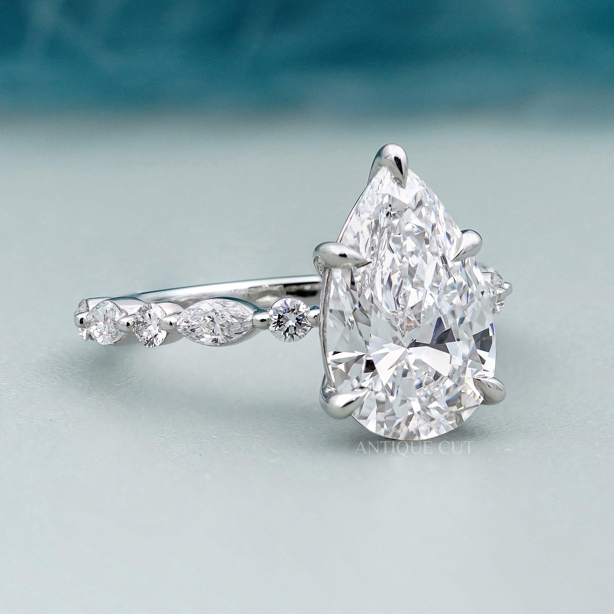 Lab grown pear side stone engagement ring