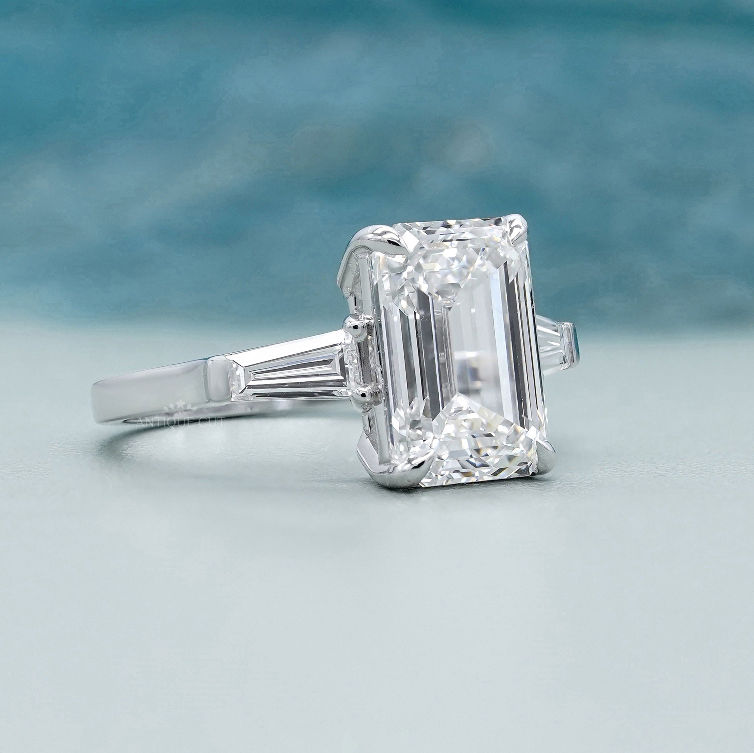 Lab grown emerald three stone engagement ring