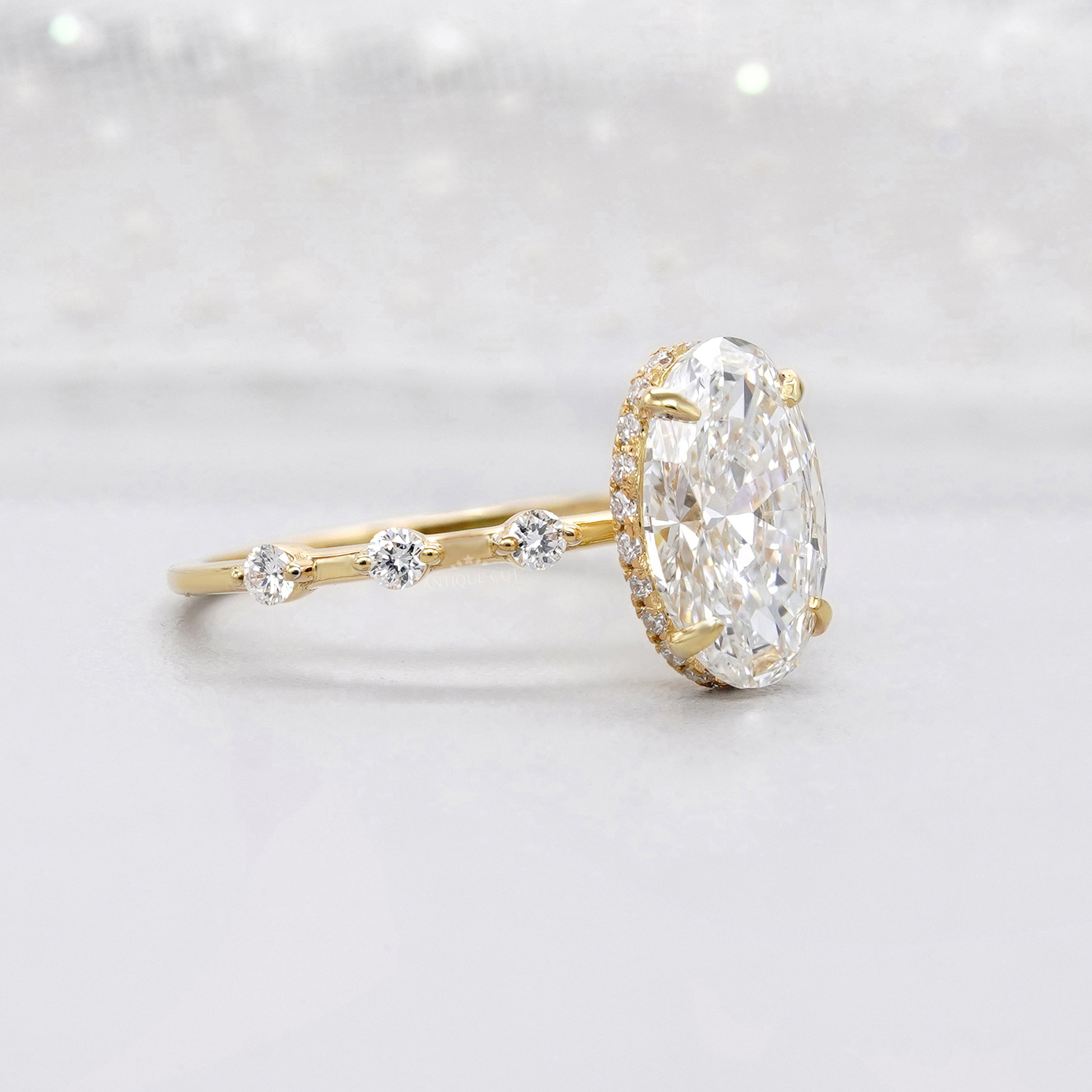 Oval cut lab grown diamond ring with hidden halo