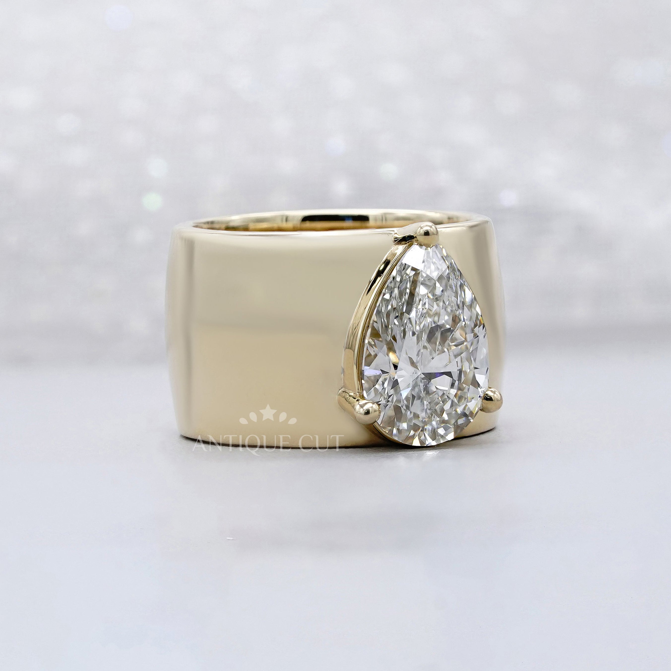 Lab grown pear cut engagement ring with wide band