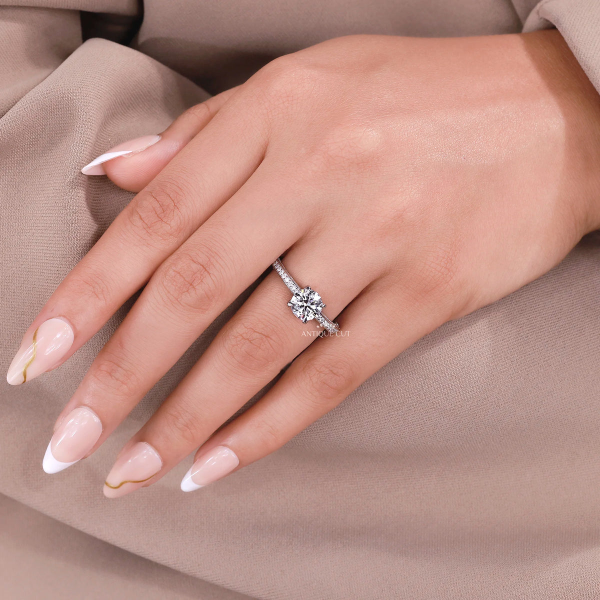 Round lab grown diamond engagement ring featuring four white gold prongs