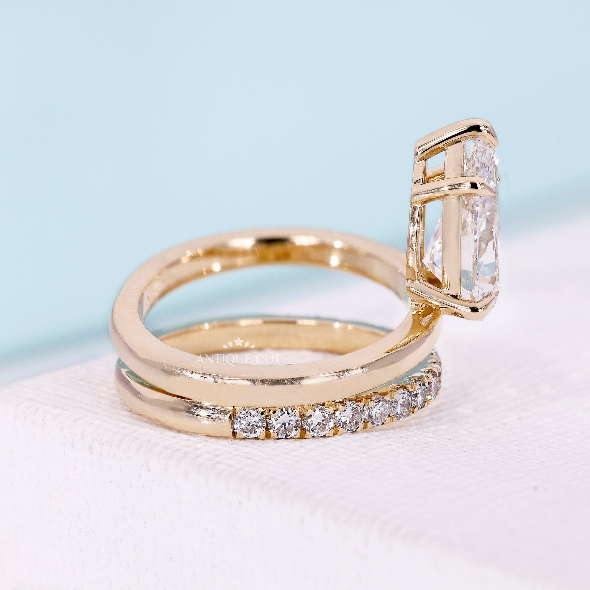 Pear engagement ring with round diamond pavé band
