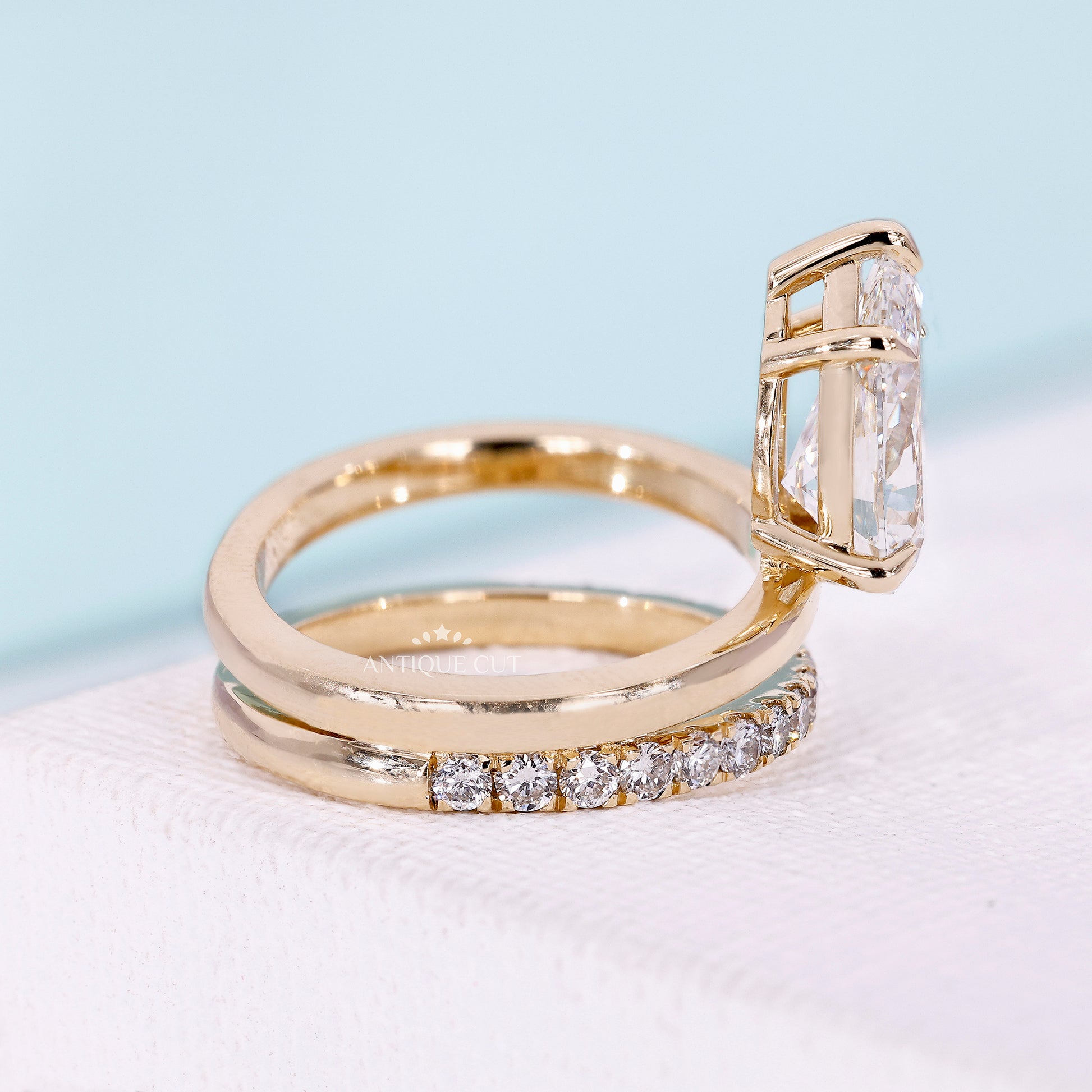 Pear engagement ring with round diamond pavé band
