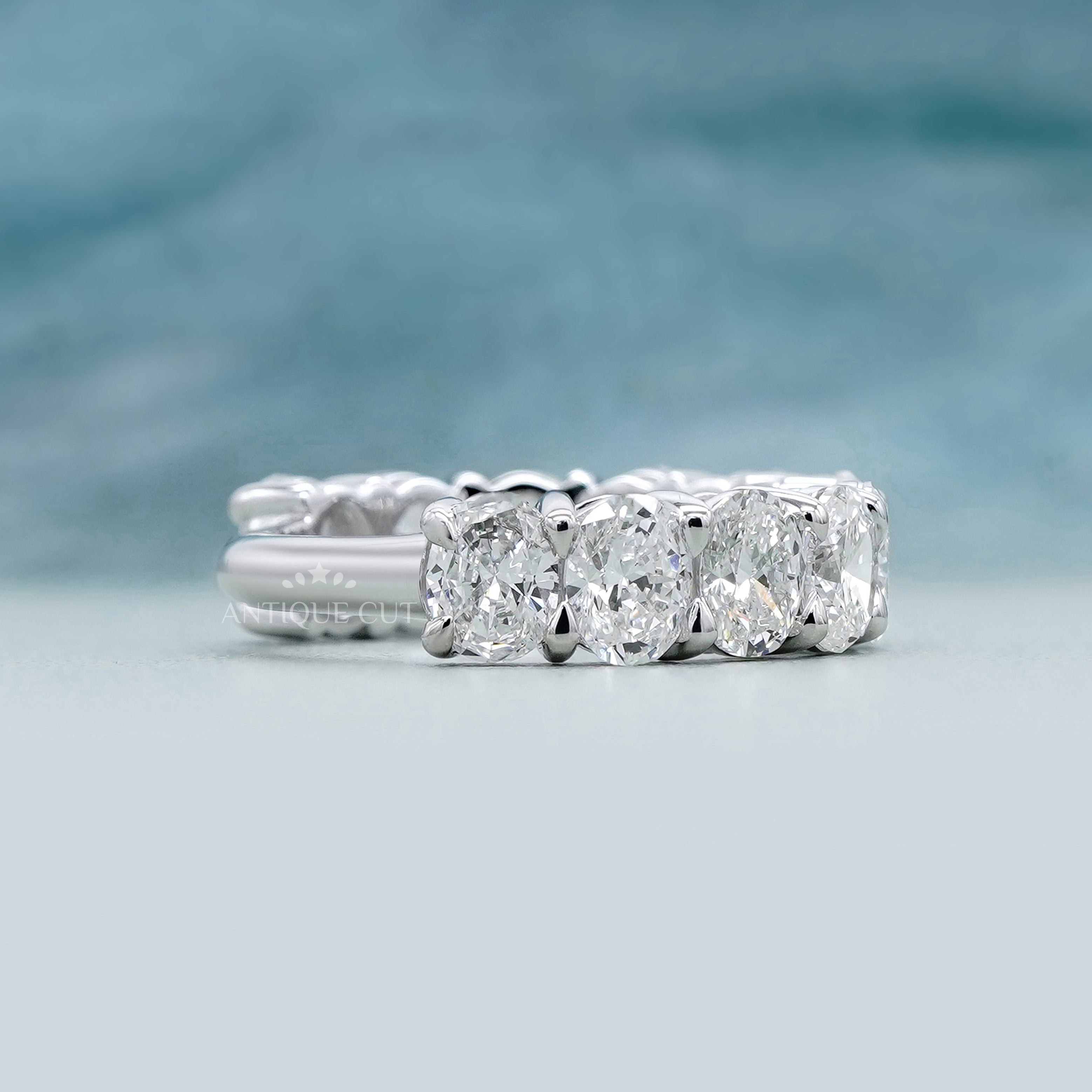 Oval cut lab grown diamond eternity band in white gold