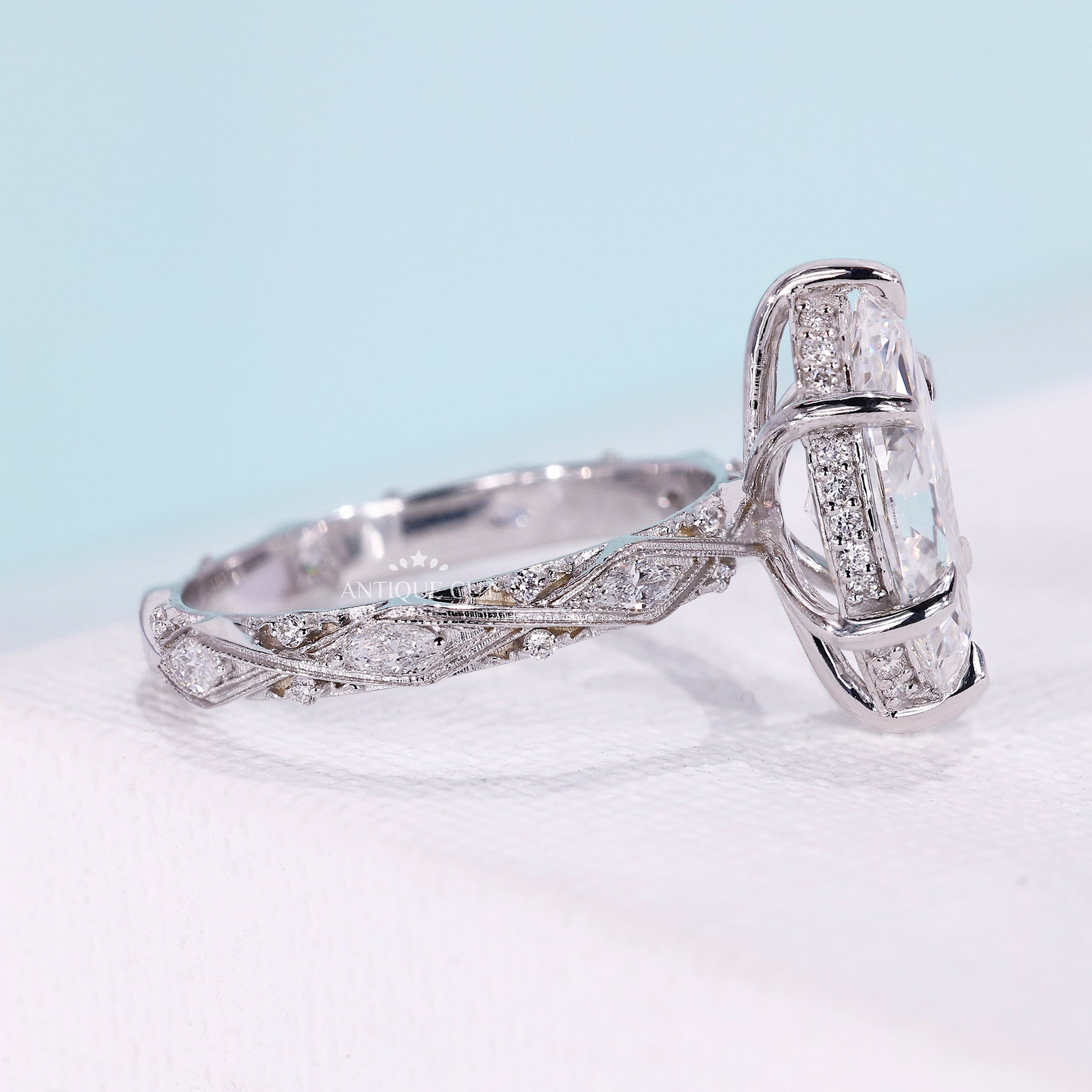 Marquise engagement ring with round cut side stones
