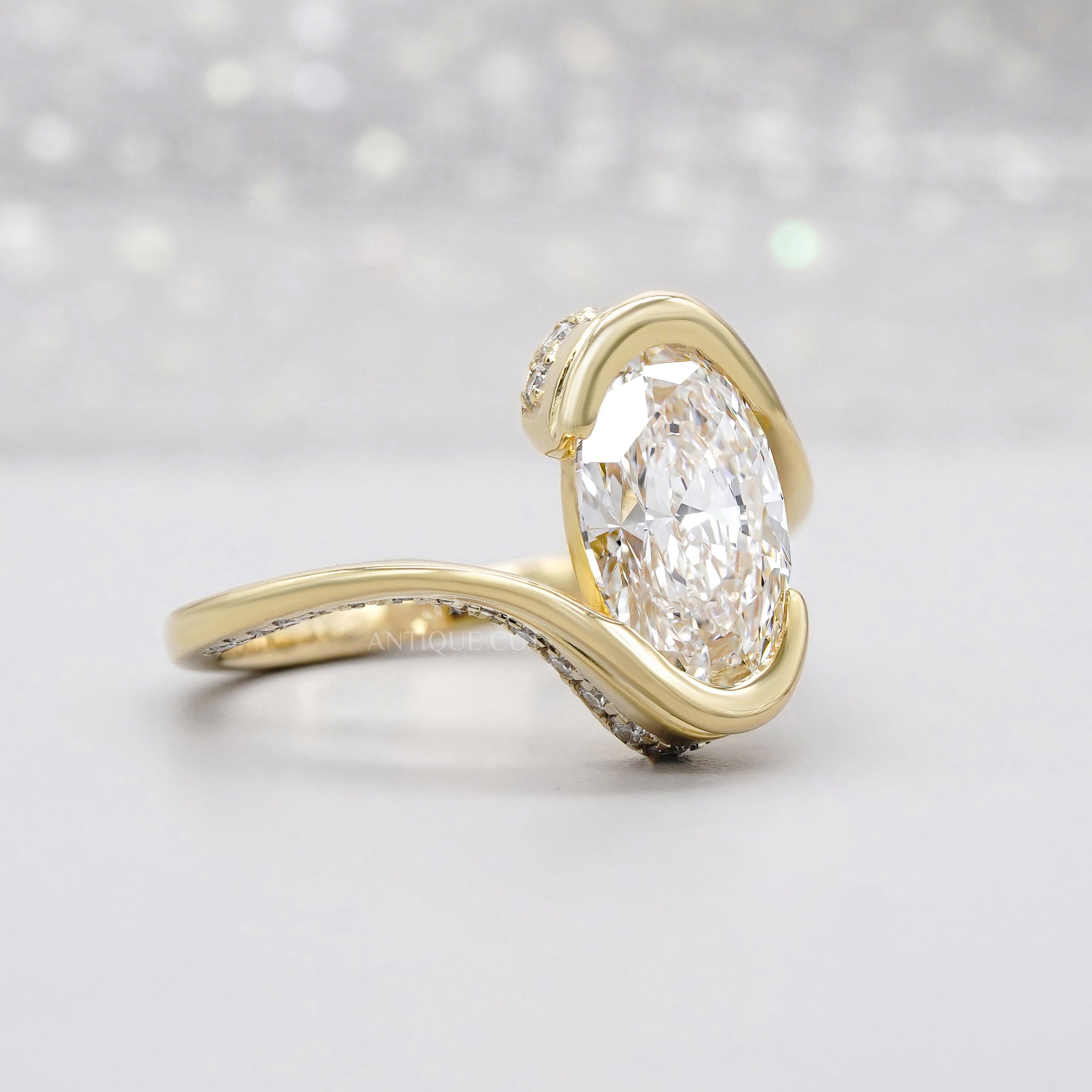 Oval bezel set engagement ring with pave band