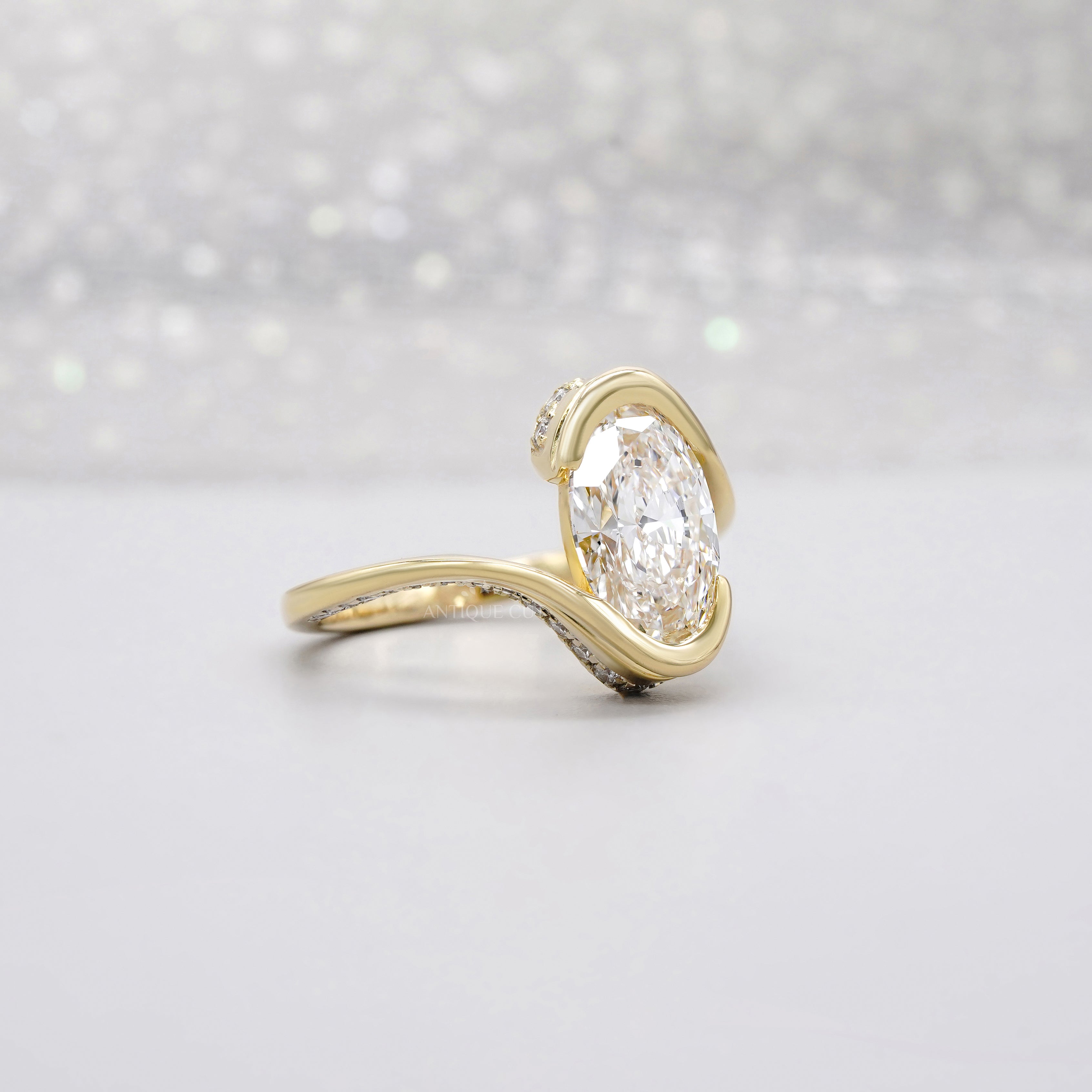 Oval bezel set engagement ring with pave band