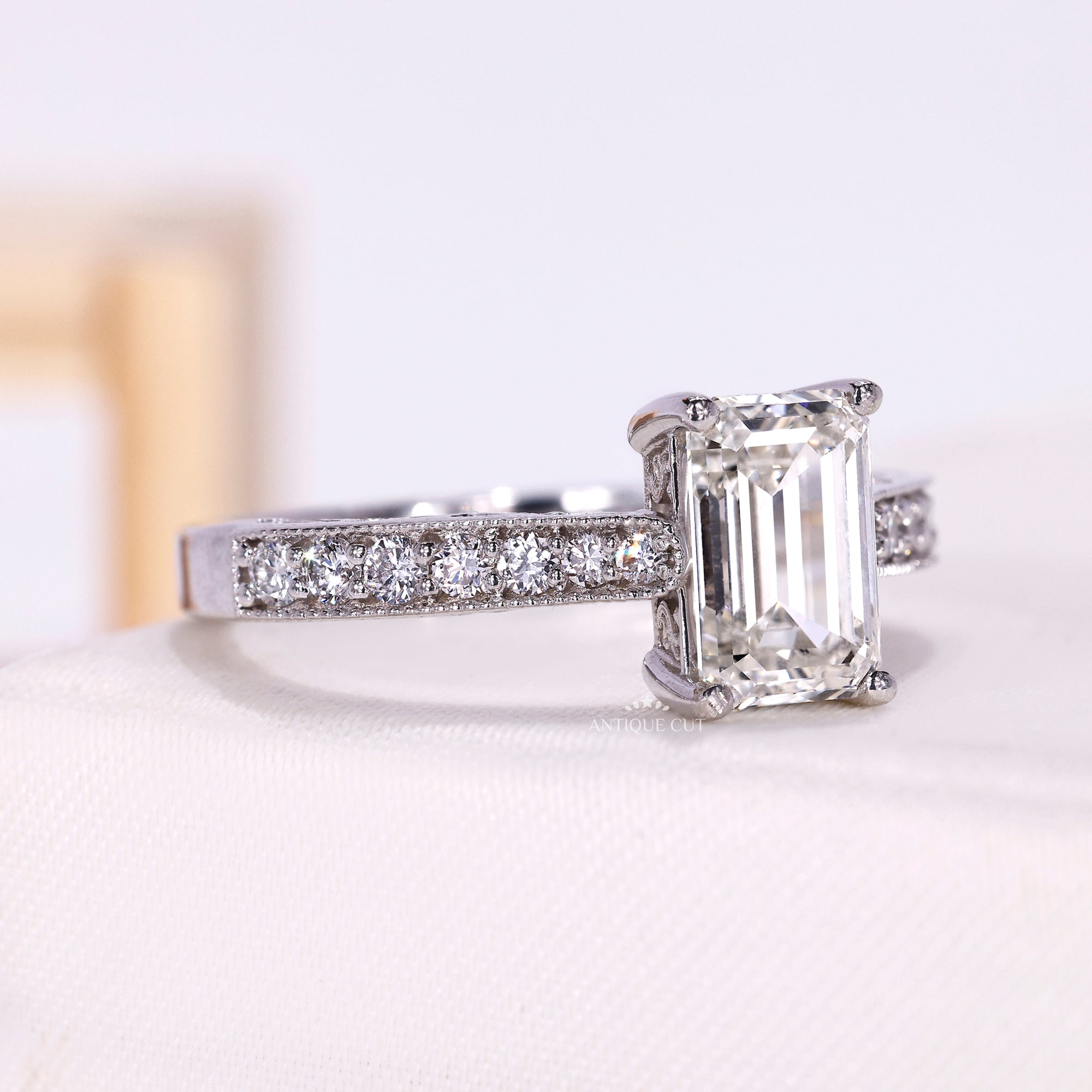 Vintage style emerald cut engagement ring with diamond pavé