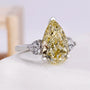 Three stone engagement ring with yellow pear center diamond