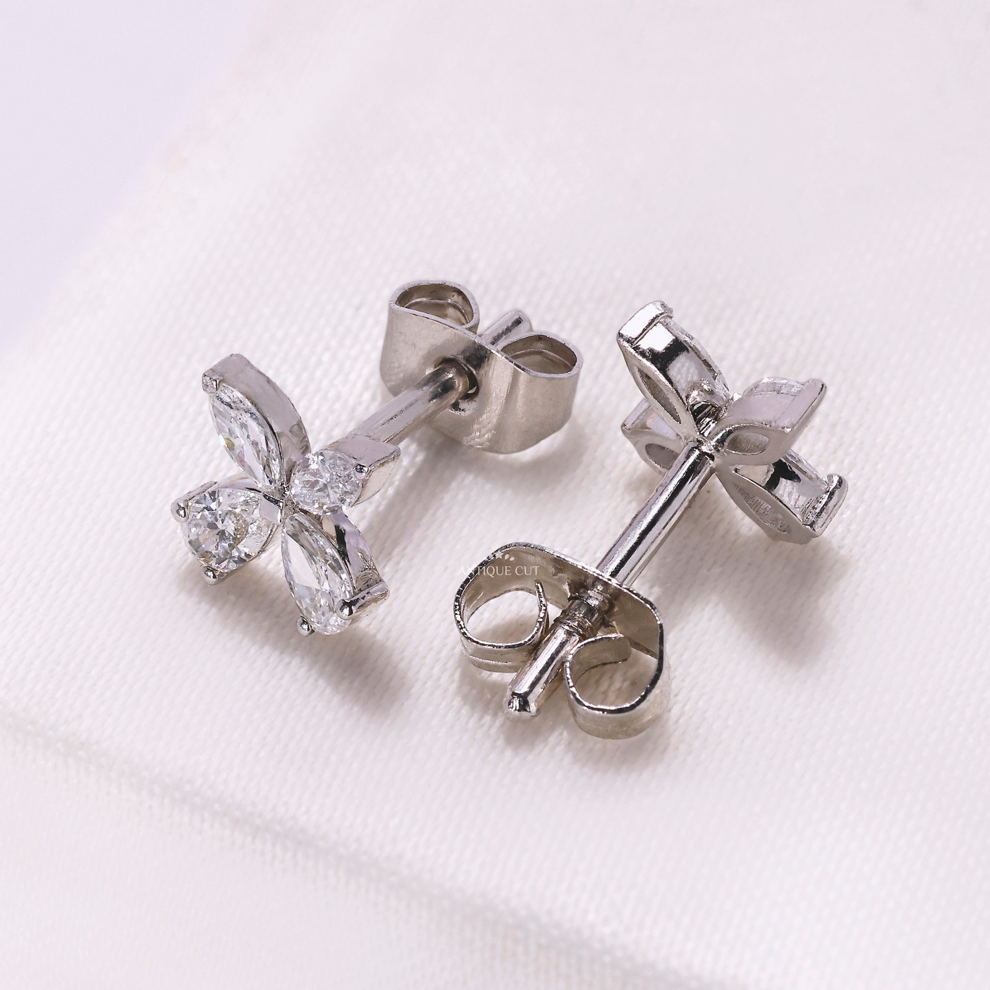 Butterfly shaped white gold earrings with diamond accents
