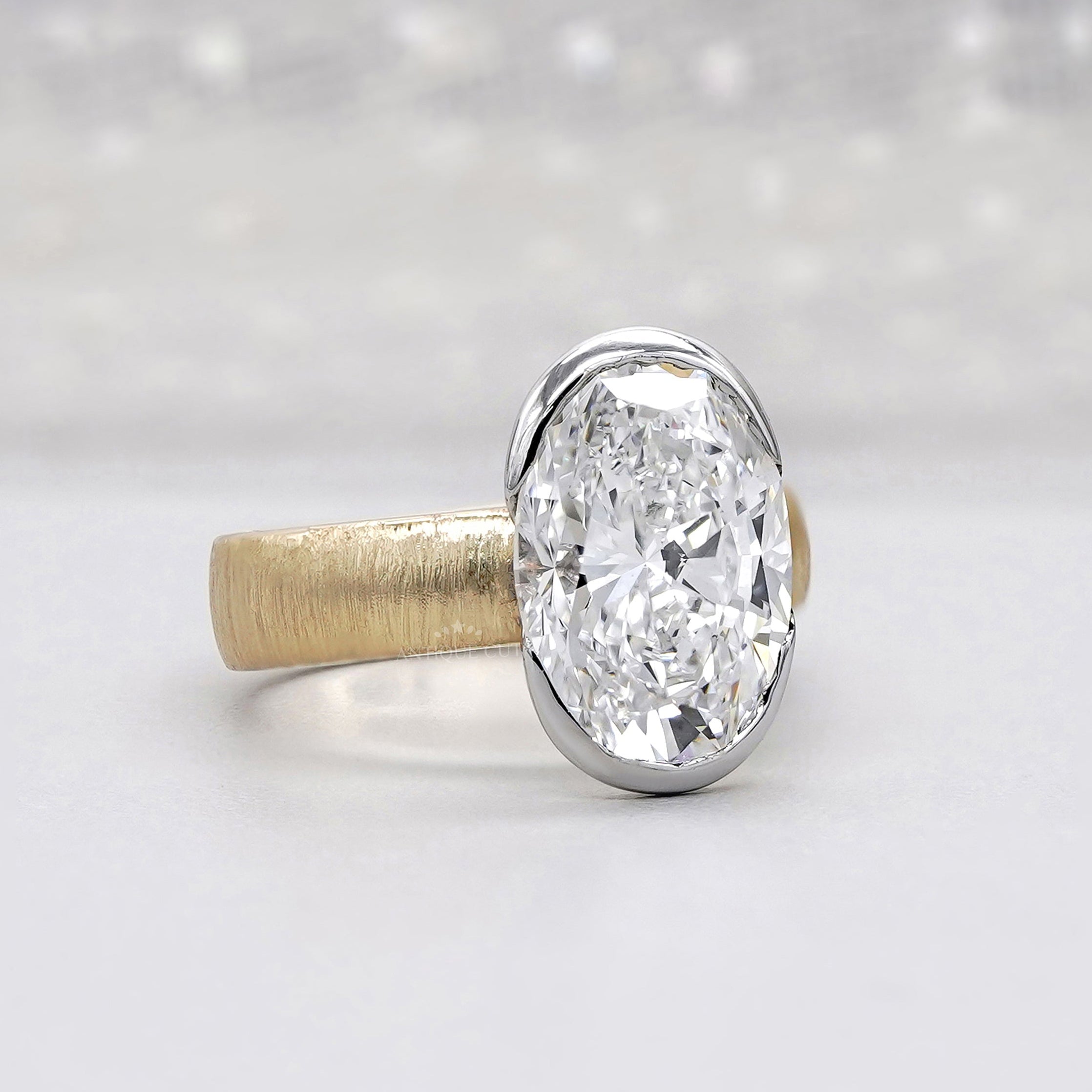 Two tone wedding ring with oval diamond in yellow gold