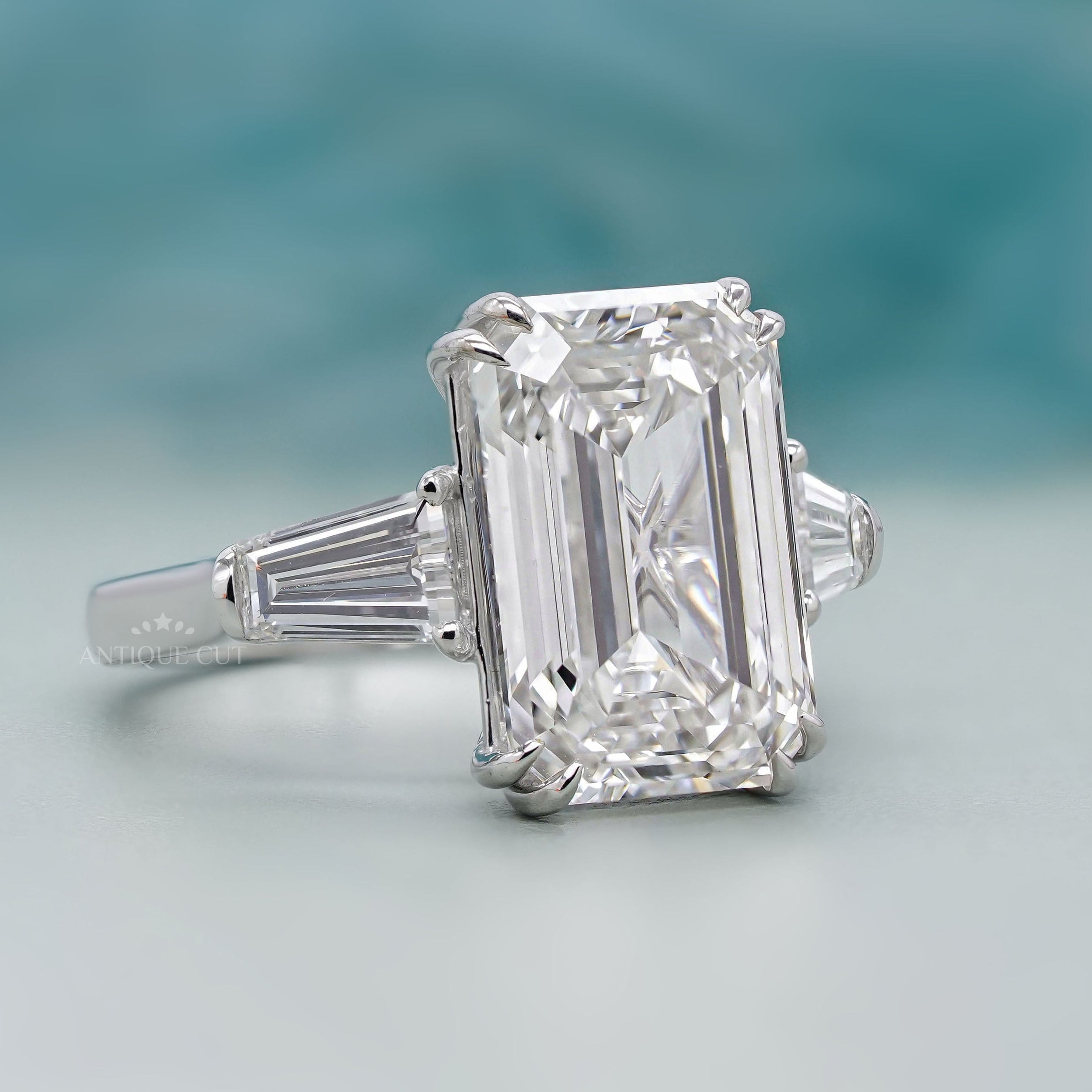 White gold emerald cut ring with tapered baguette diamonds