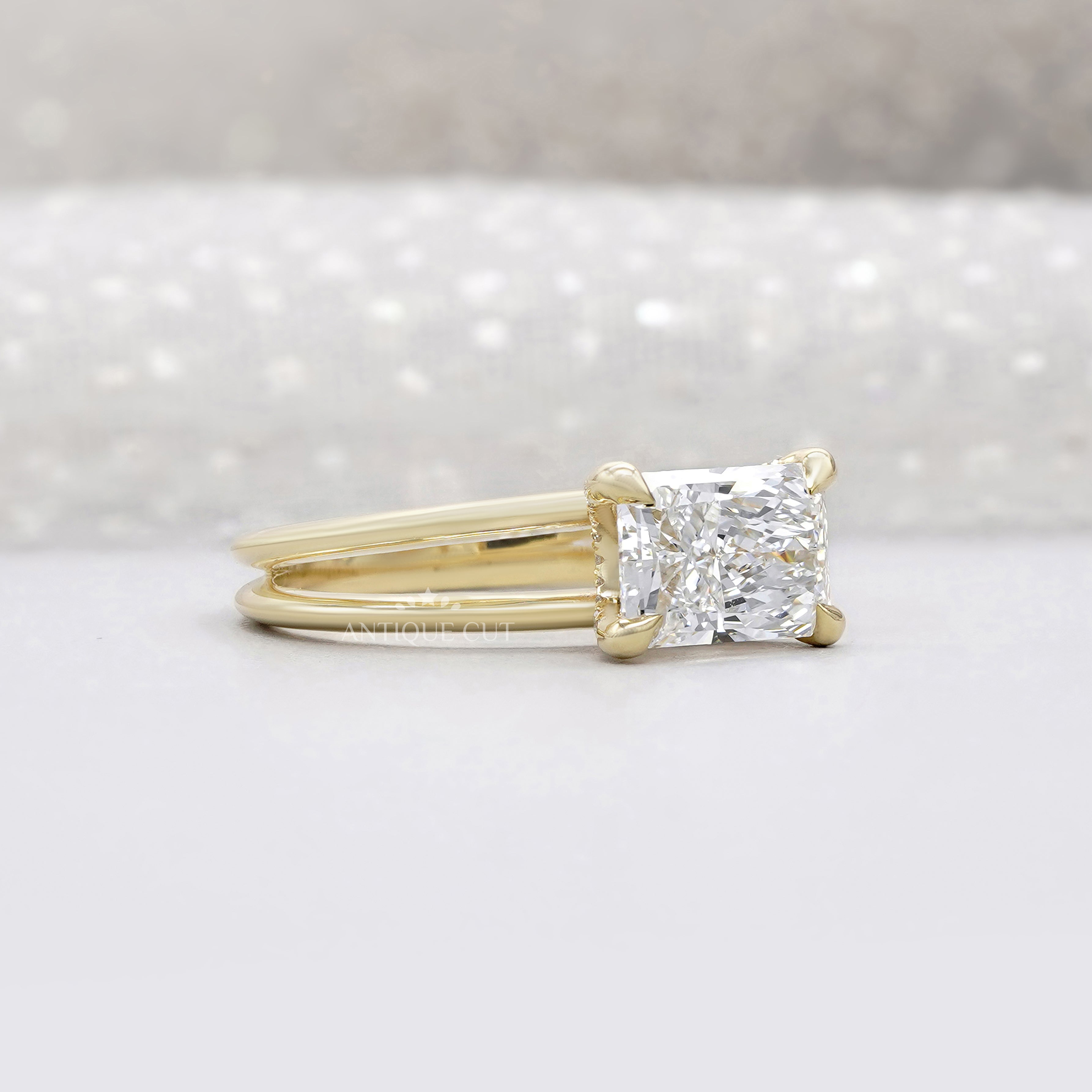 Yellow gold radiant diamond ring with east west setting