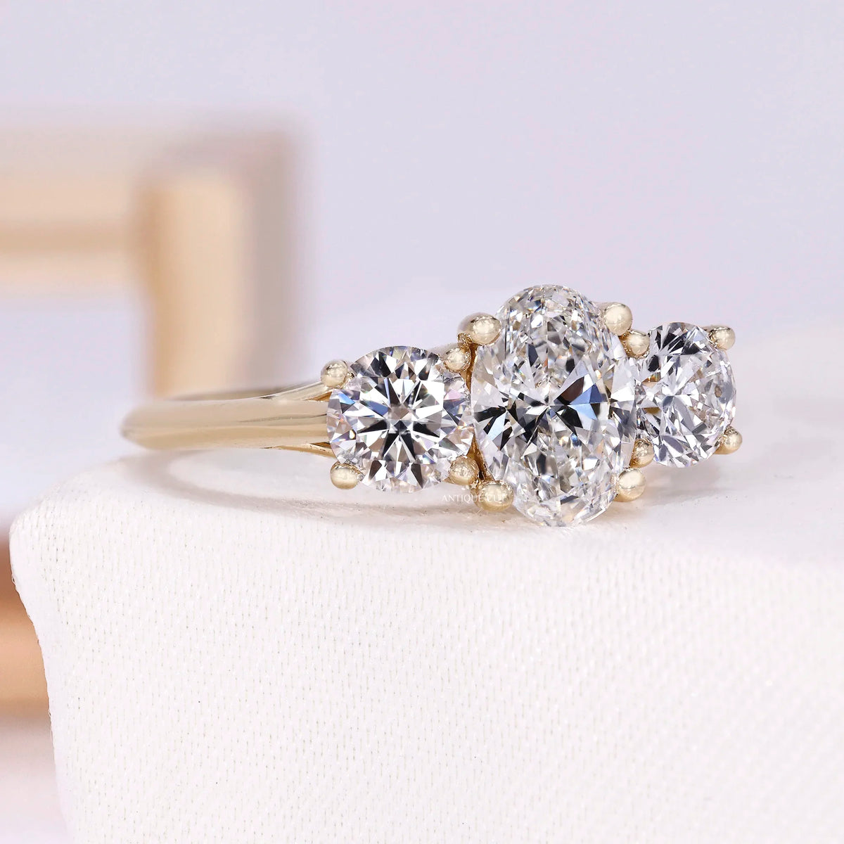 1.50 Carat Lab Grown Oval Cut Center Diamond & Two Round Side Stones With Trellis Gallery Setting