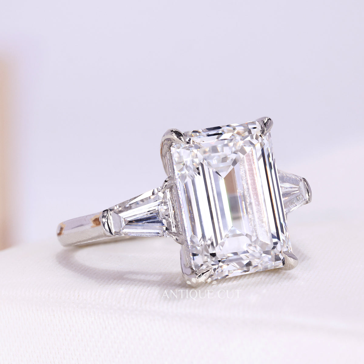 Emerald cut engagement ring with tapered baguette side stones