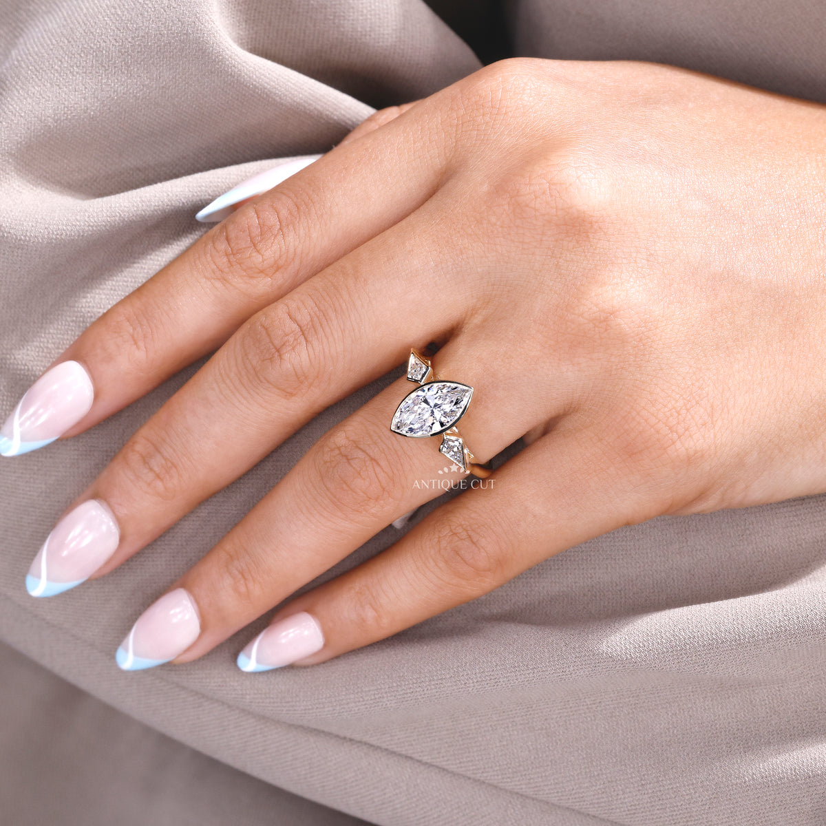 Three stone diamond ring with marquise center