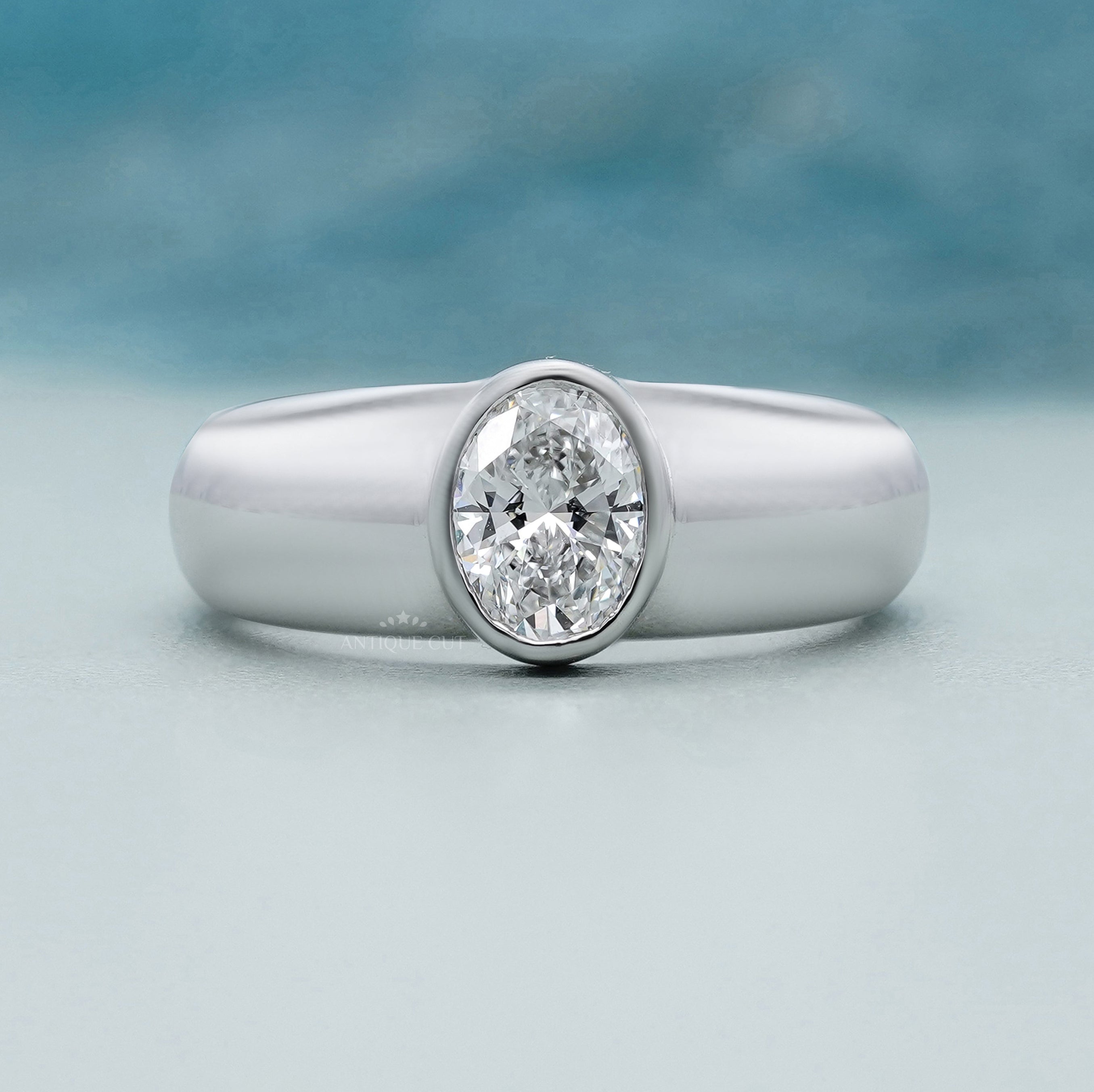 Bezel set oval engagement ring in white gold