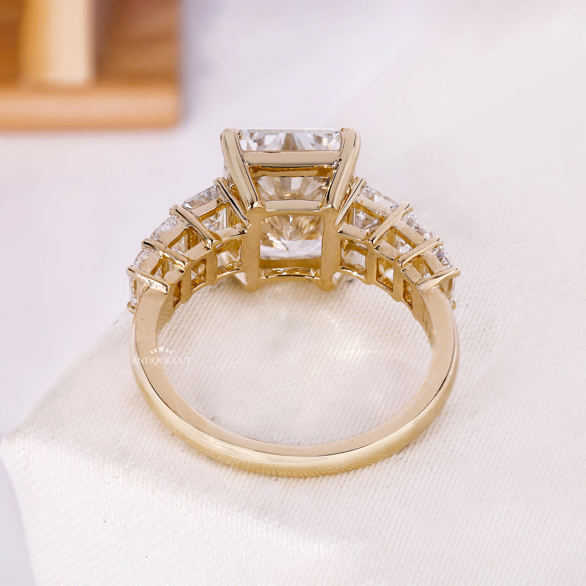Angled view of radiant cut ring with step cut side stones