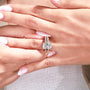 Yellow gold band supporting the center and side stone settings