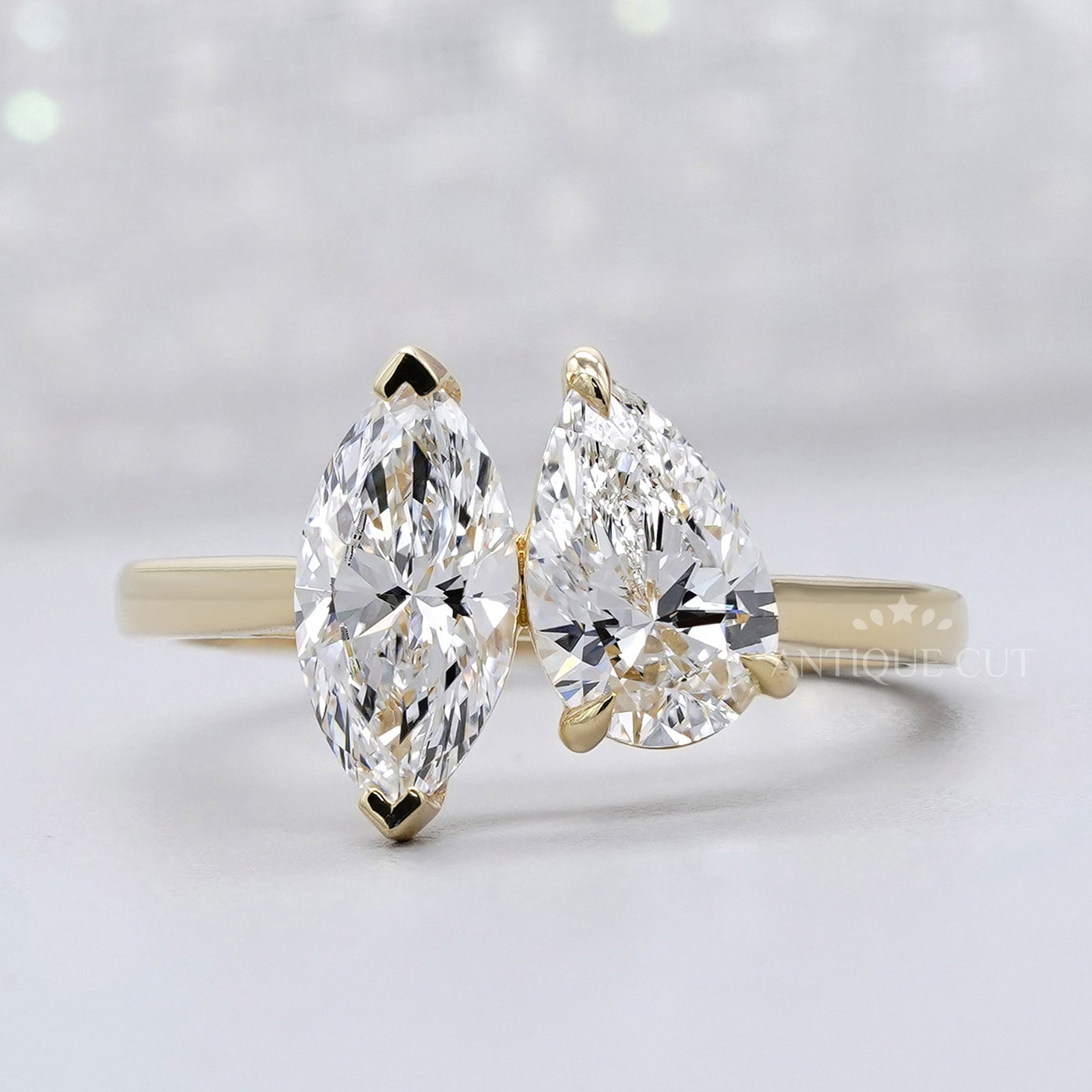 Pear and marquise two stone engagement ring in yellow gold
