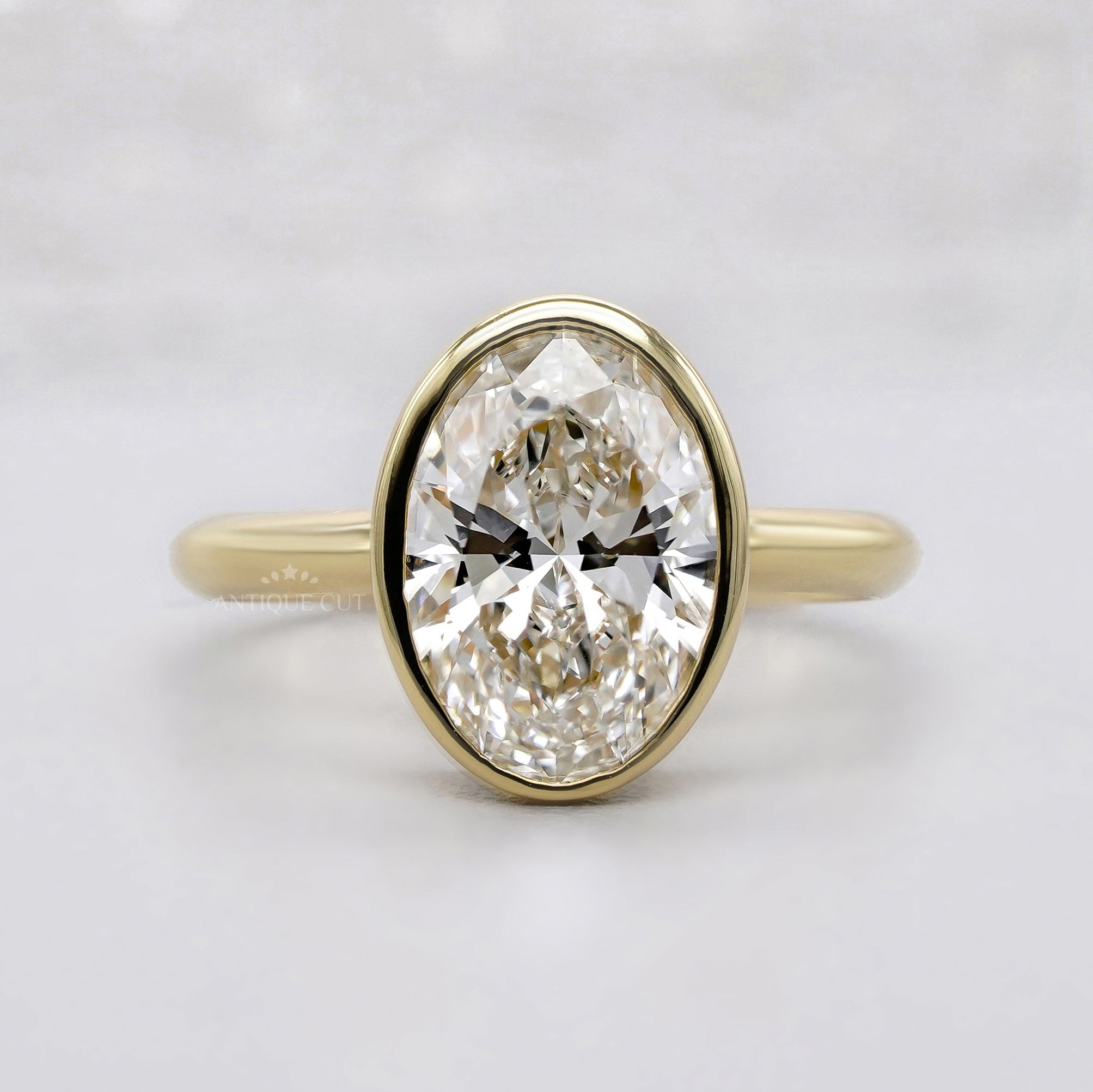 Oval solitaire engagement ring in yellow gold