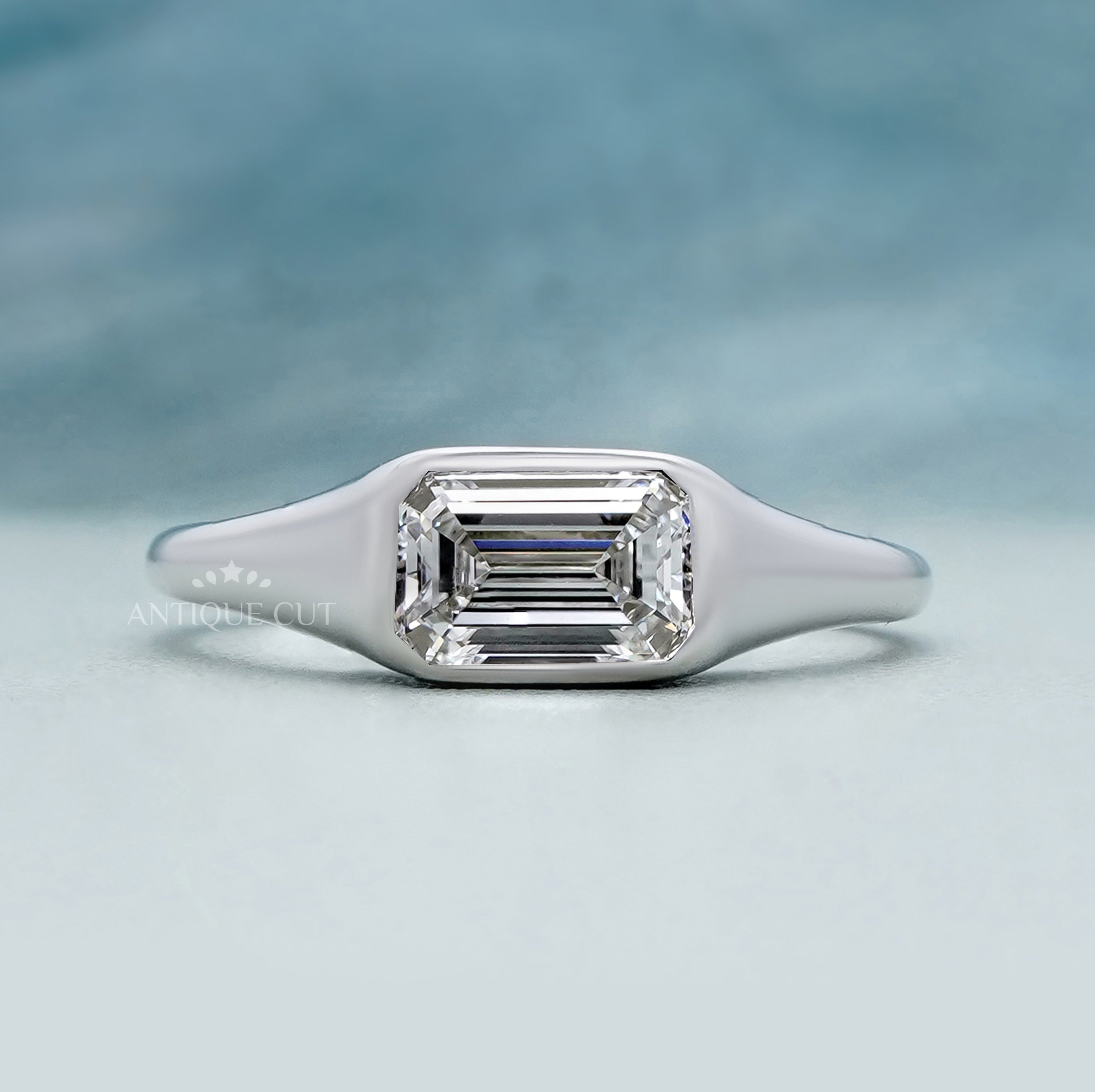 East West emerald cut diamond ring in white gold
