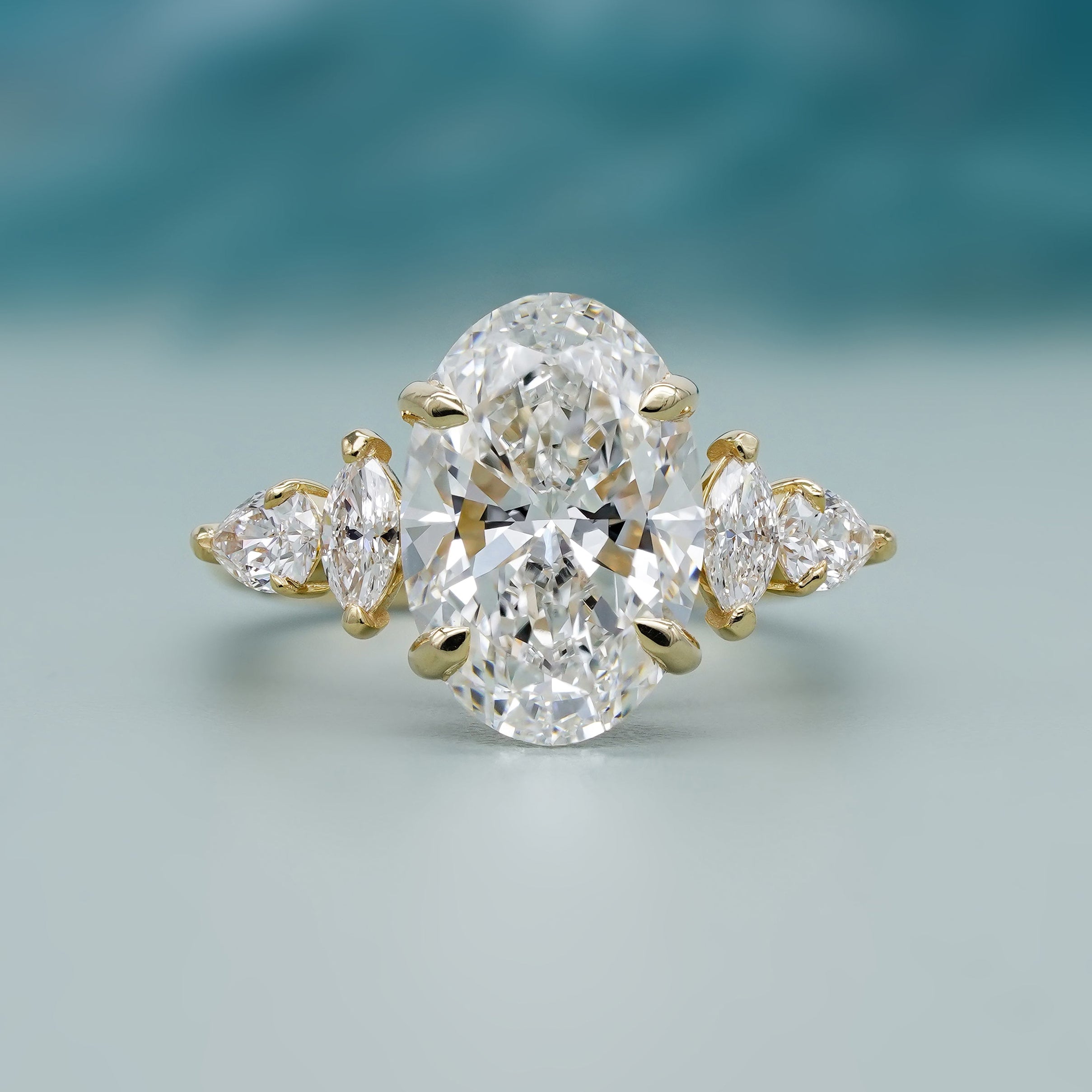 Cathedral set ring with oval diamond and marquise side stones