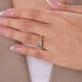 Emerald shape diamond with clipped corners in a yellow gold ring