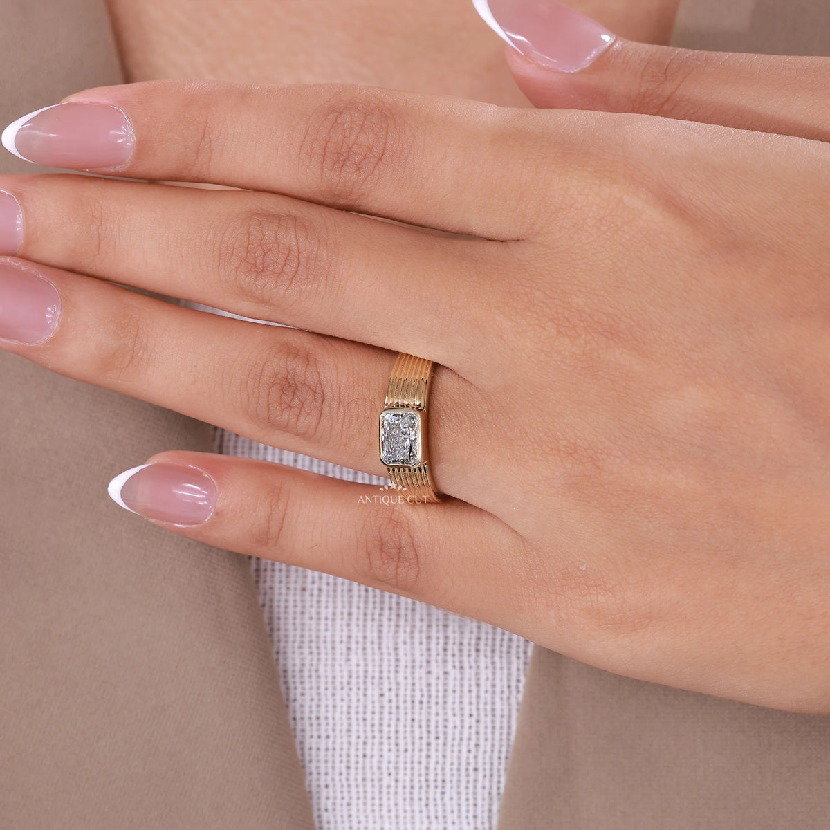 Emerald shape diamond with clipped corners in a yellow gold ring