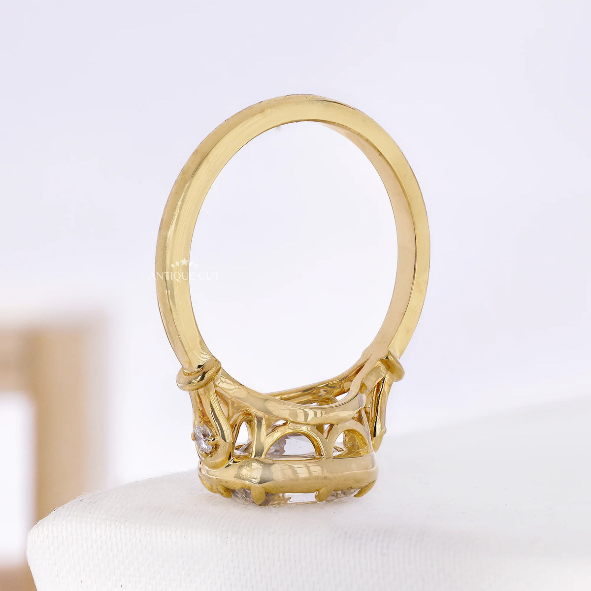 Front view of elongated cushion diamond positioned across the band