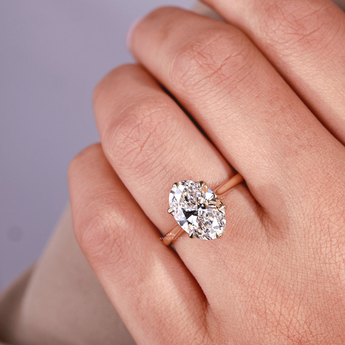 Tulip setting oval diamond engagement ring in yellow gold
