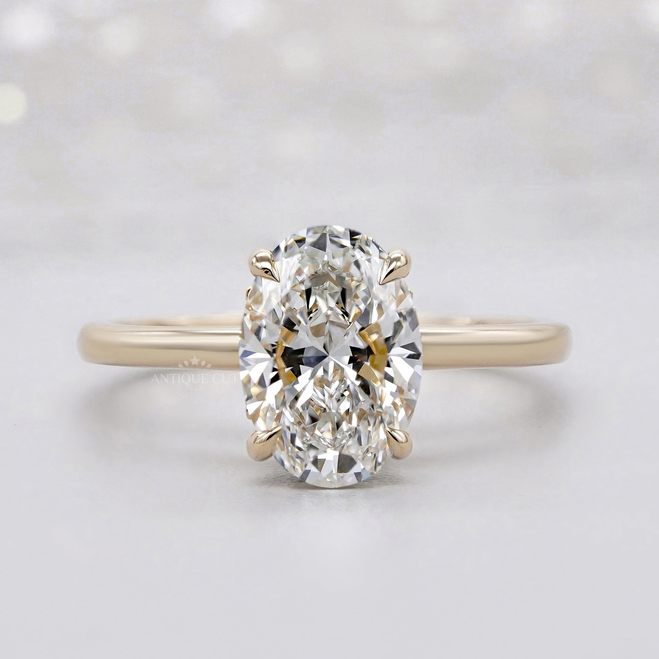Oval hidden halo engagement ring in yellow gold